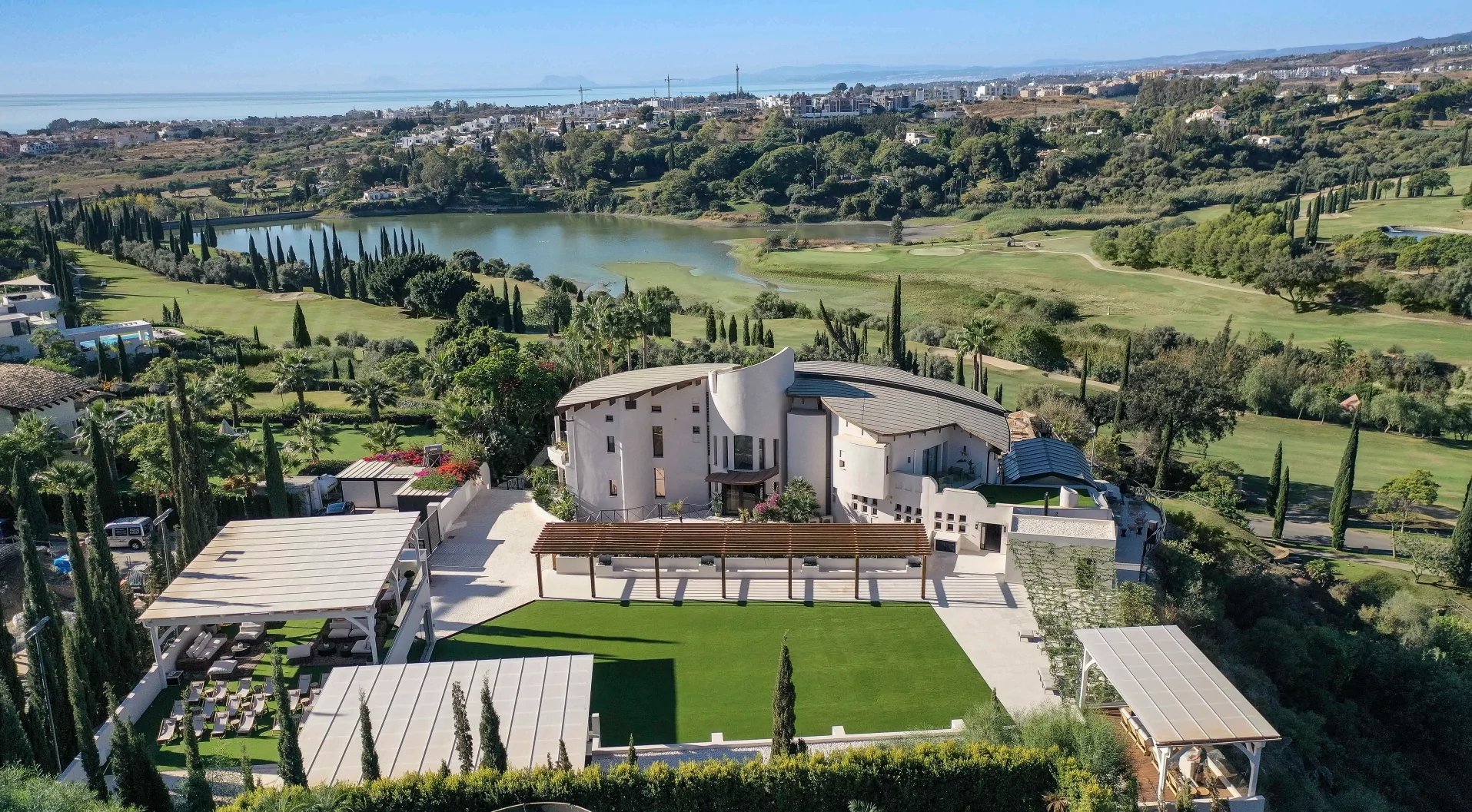 Aerial view of estate with flat lawn and pergola spaces