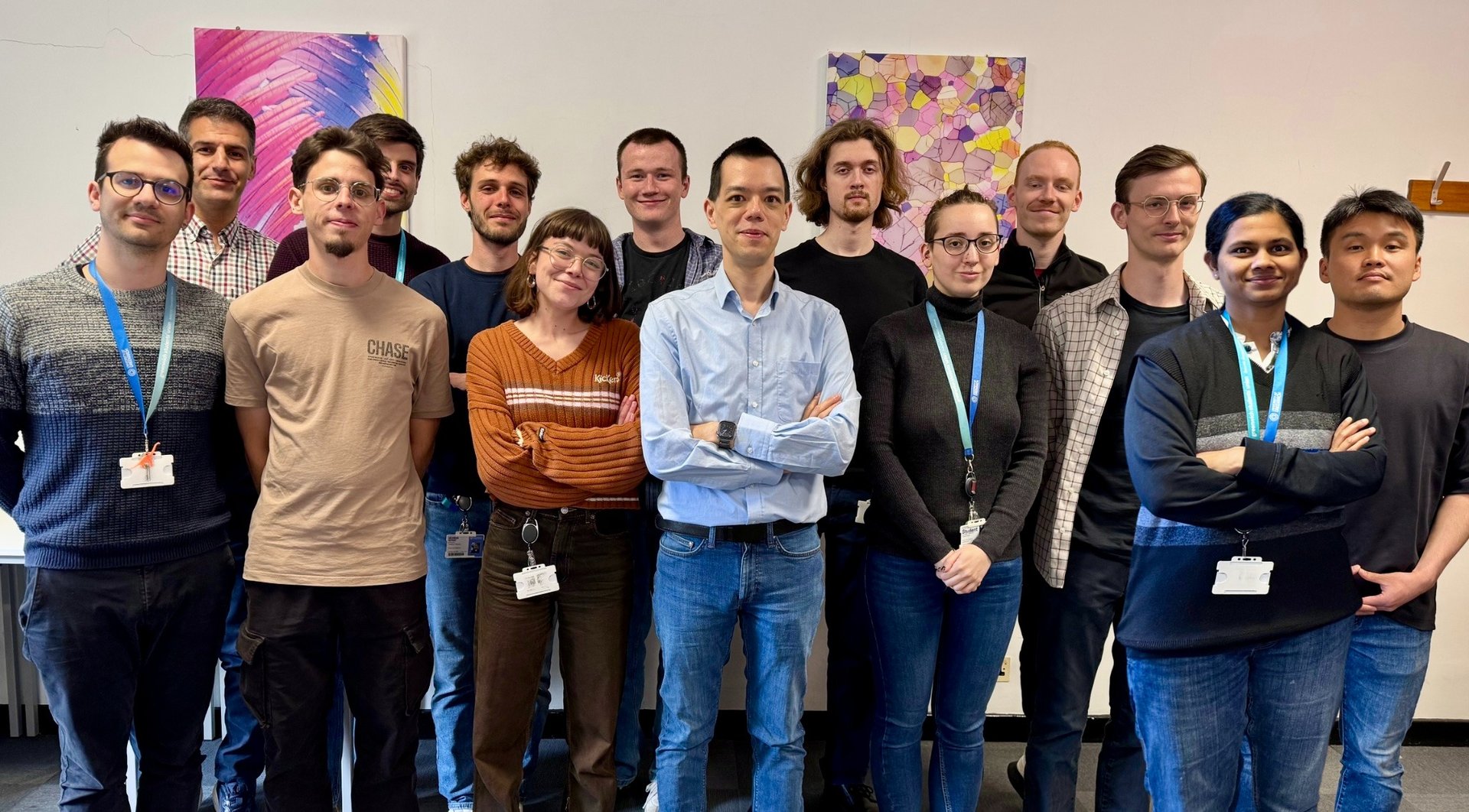 a group of people standing in front of a wall