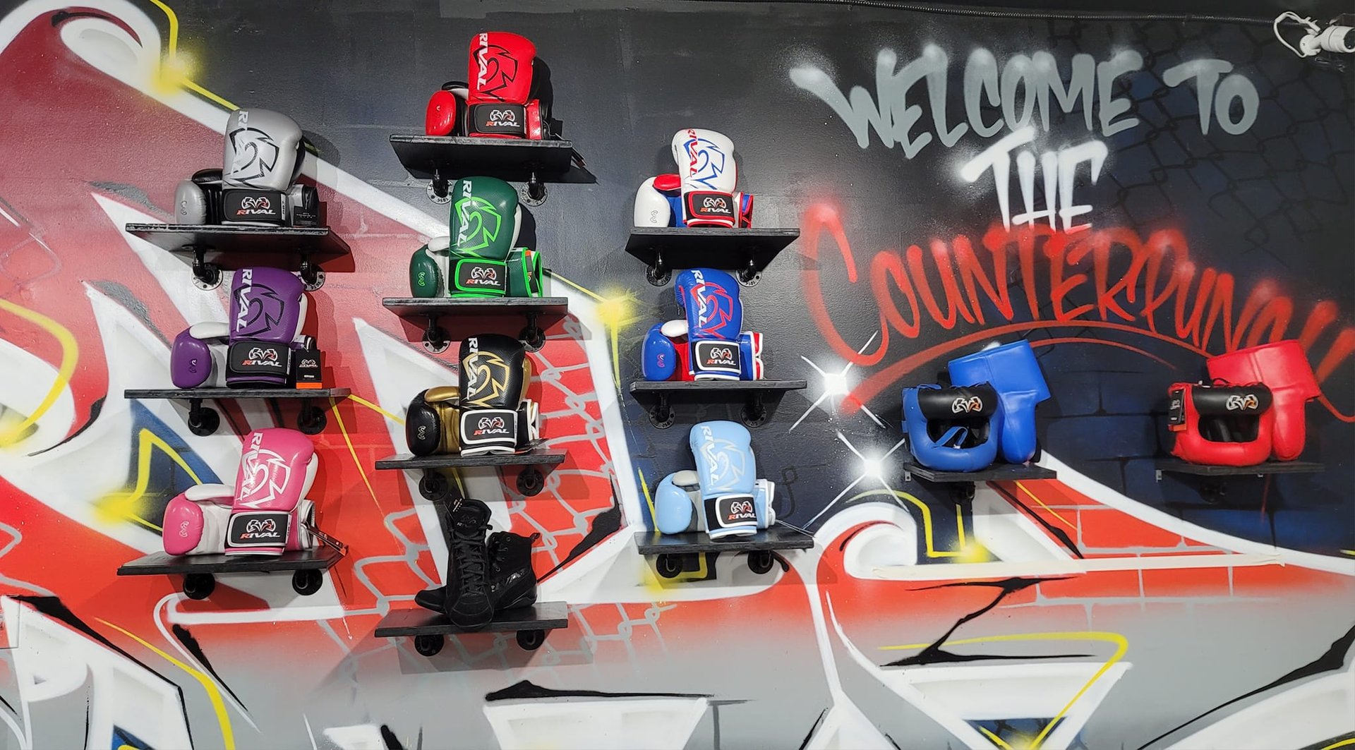 the counterpunch boxing club wall with welcome graffiti and boxing gear mounted to the wall