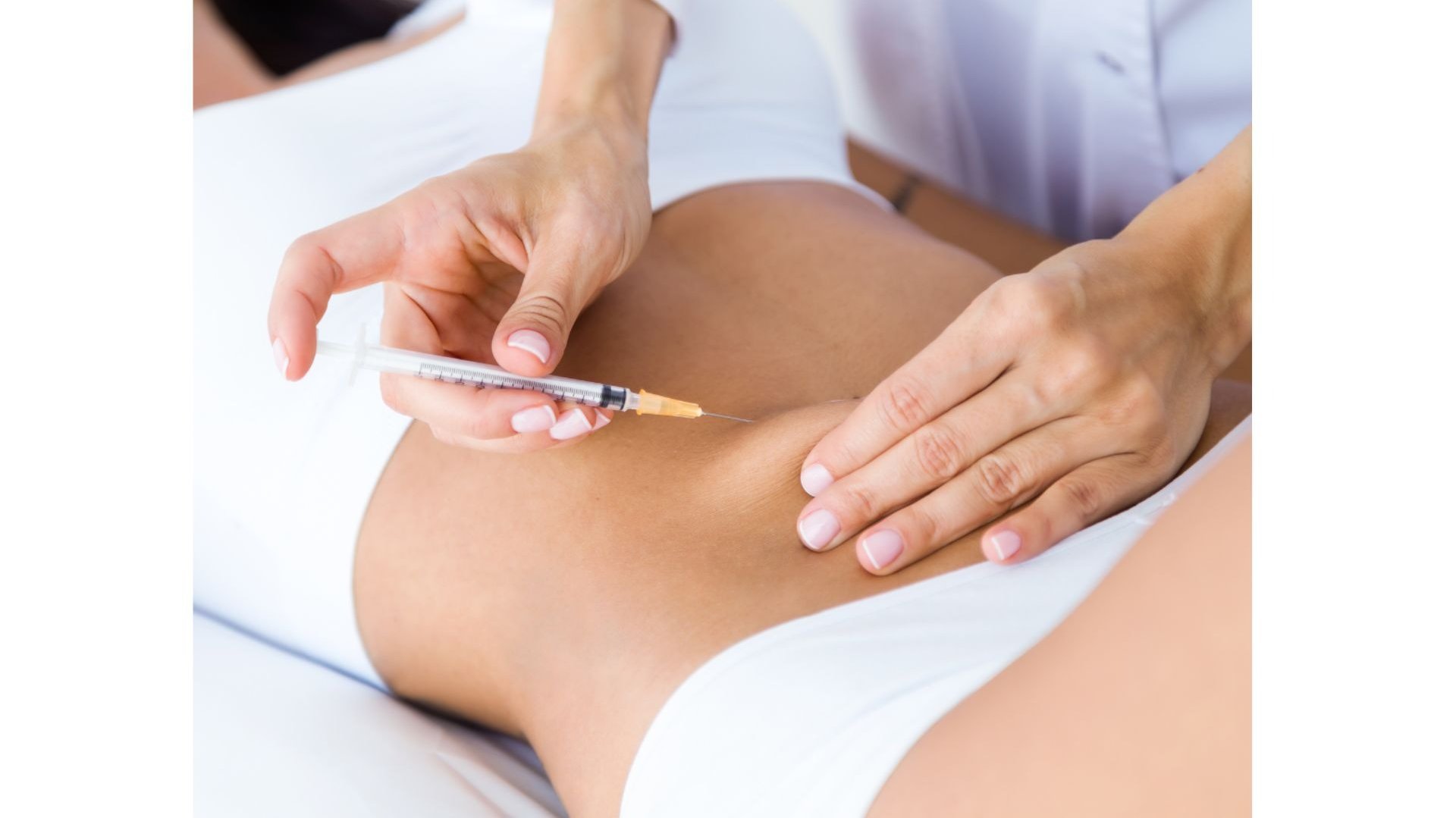 Professional administering a lipolysis injection to a patient's abdomen for fat reduction treatment.