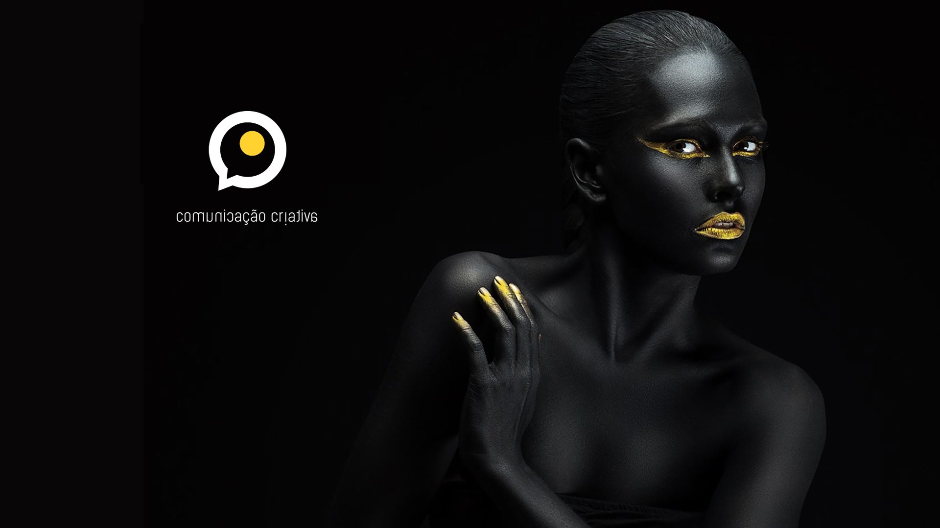 a woman with black and gold makeup and gold makeup