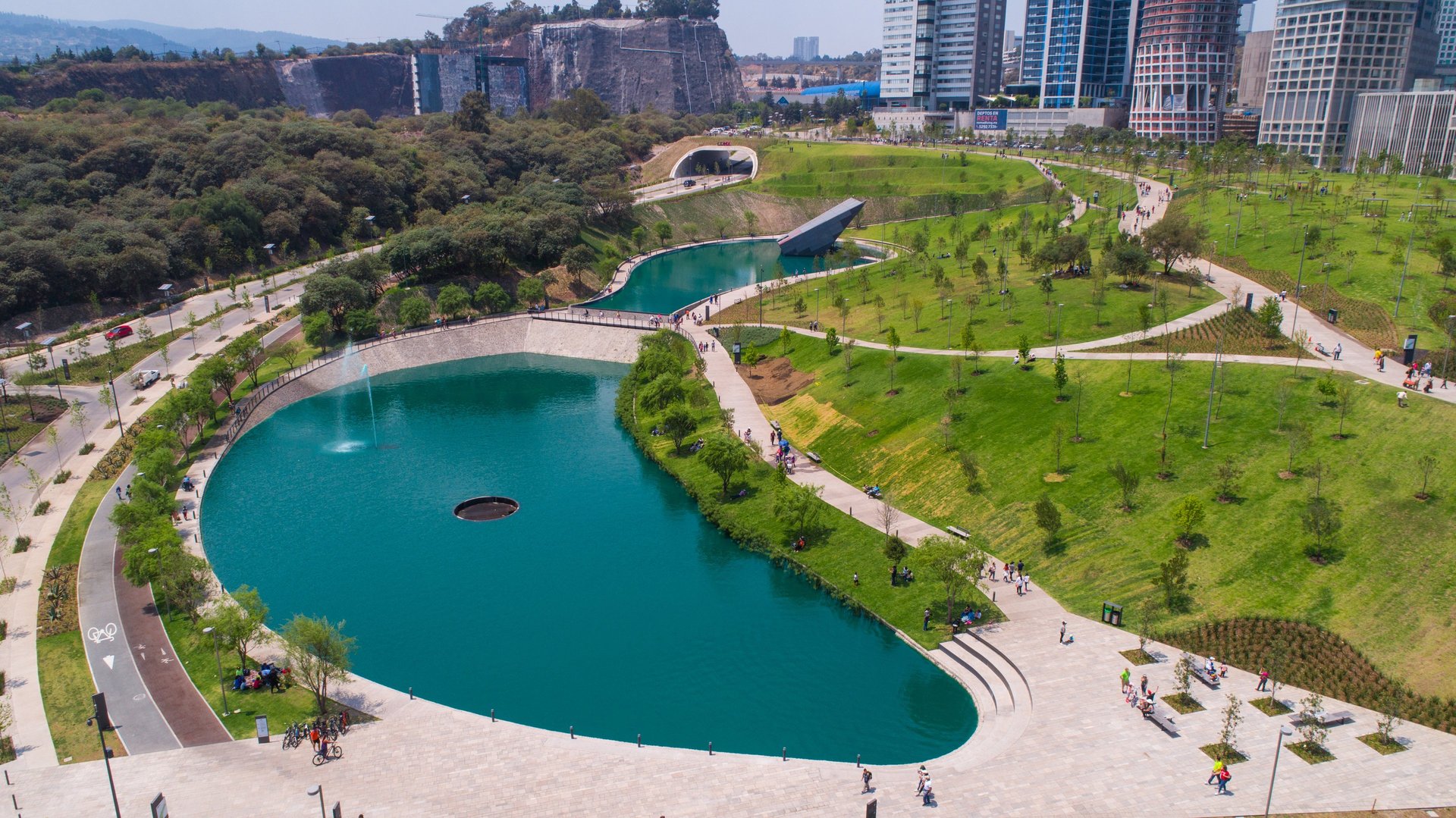 a large pond with a fountain and a fountain