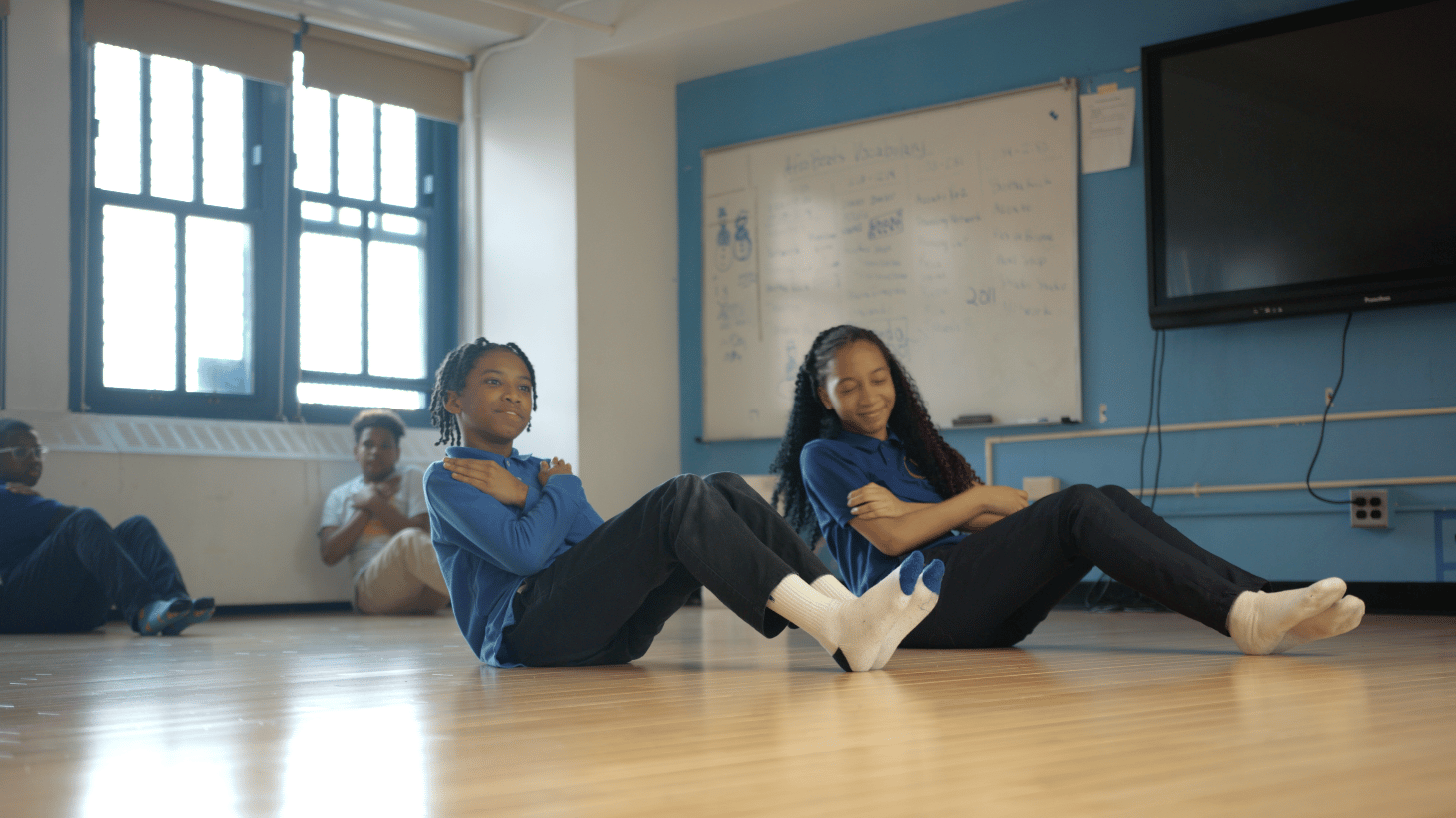 Students doing an abdominal exercise.