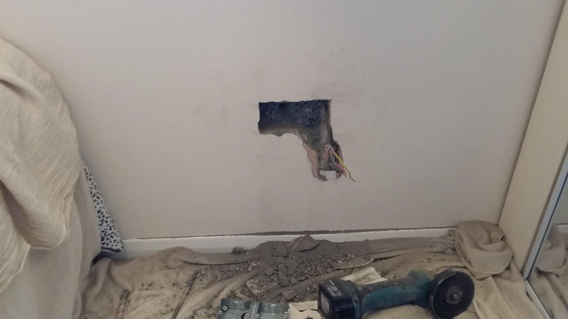 Wall being chased to fit a fused spur