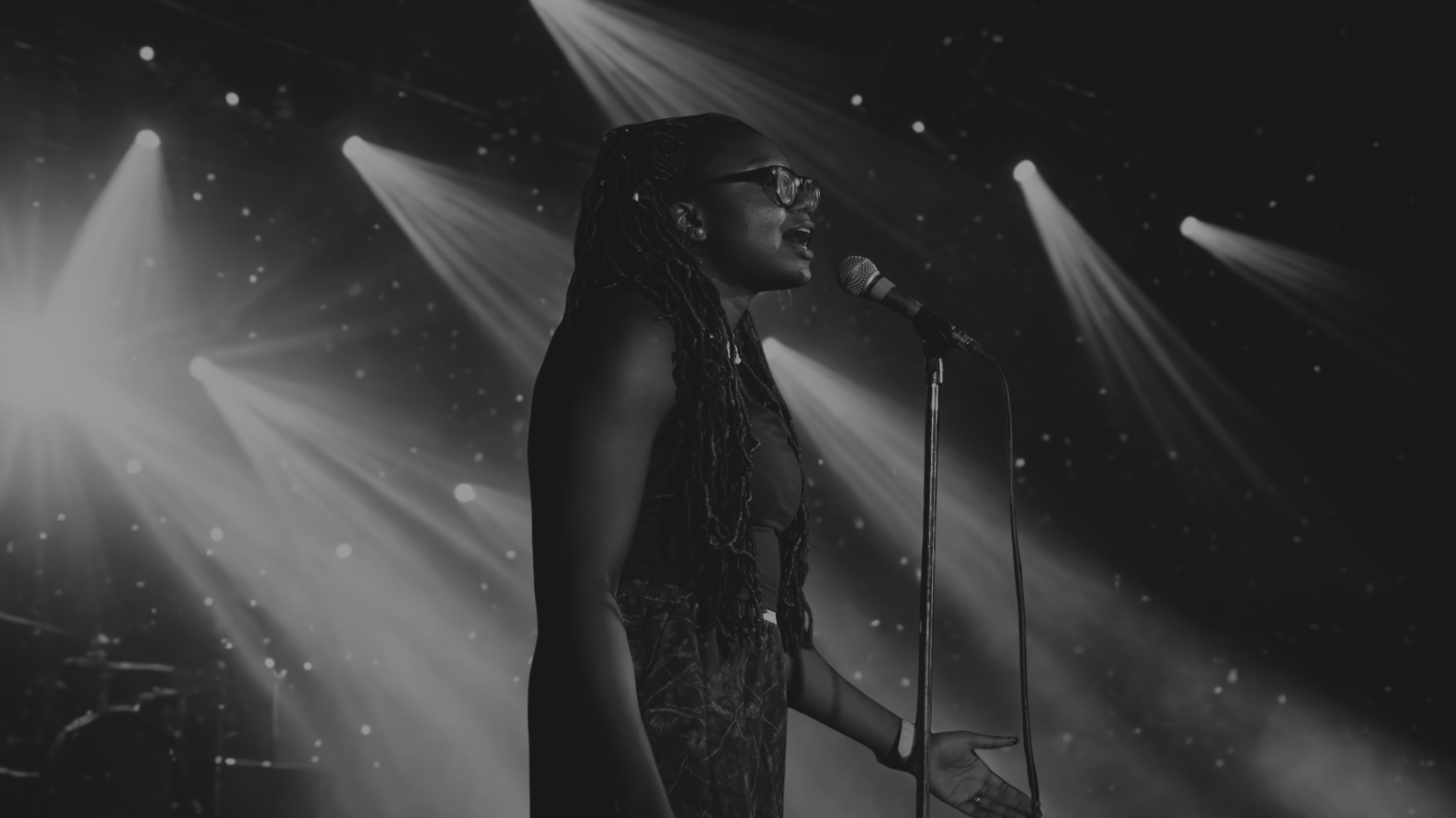 Iheoma Uzomba performing poetry on stage Vancouver