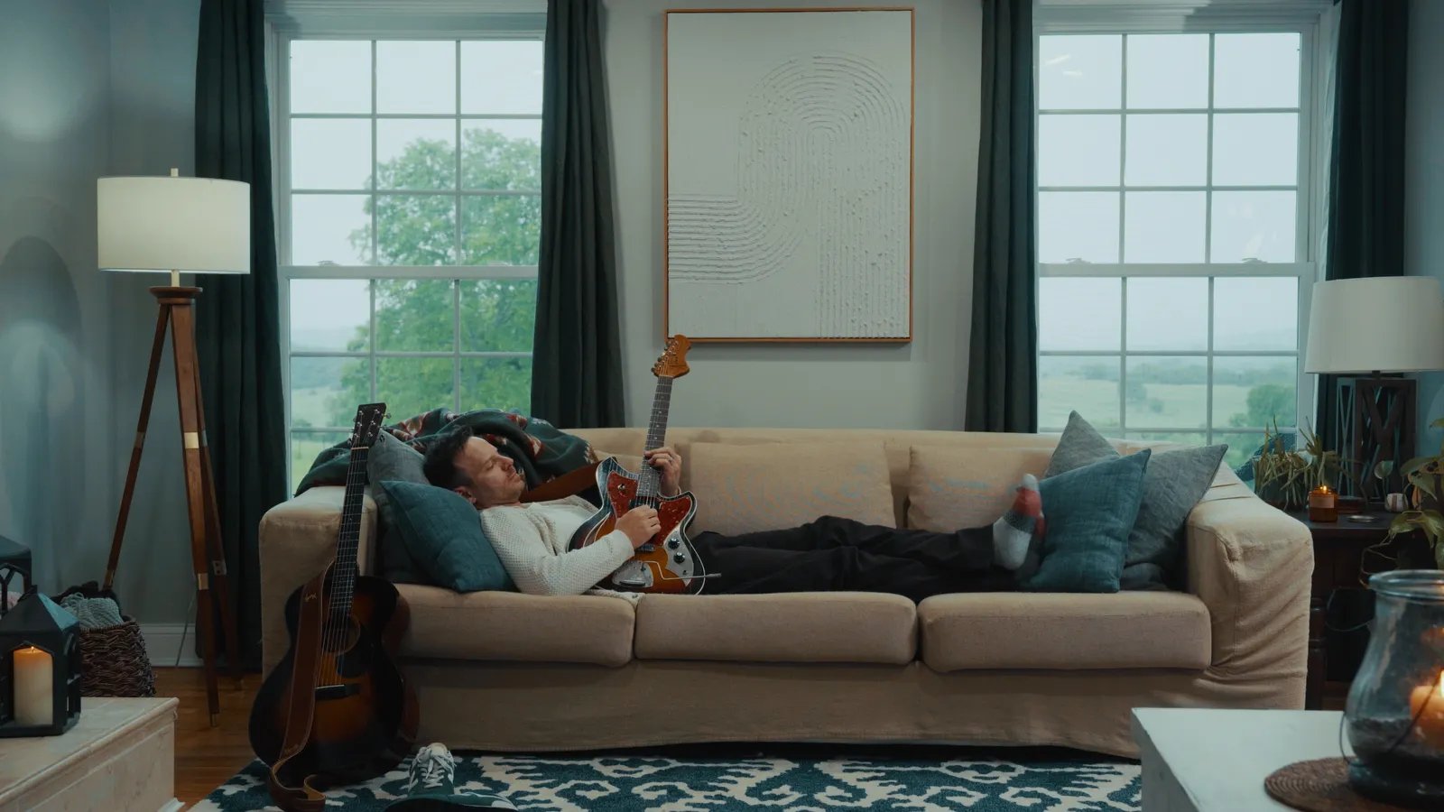 a man laying on a couch in a living room