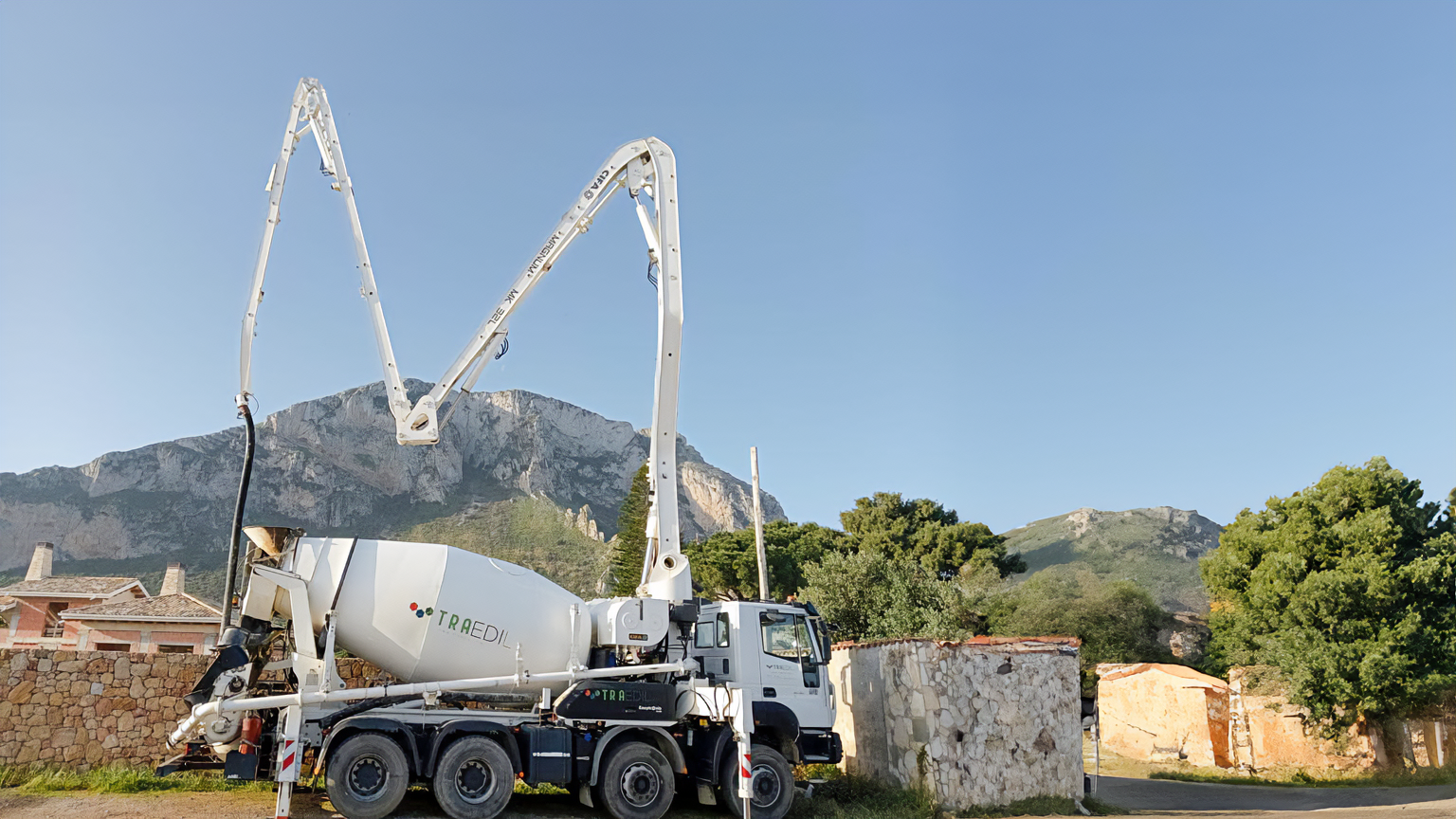 a cement mixer truck with a man standing next to it