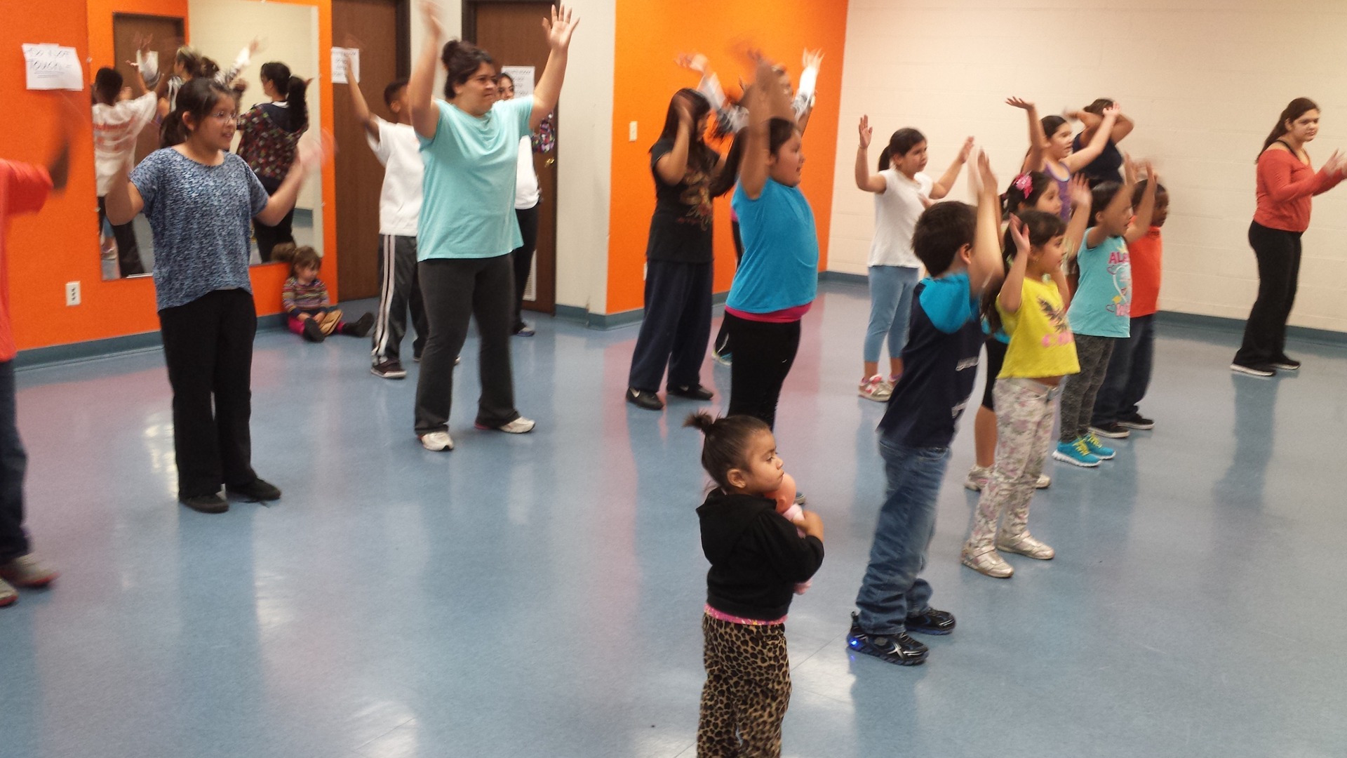 Enhancing Forward Action image of a group of children excising.