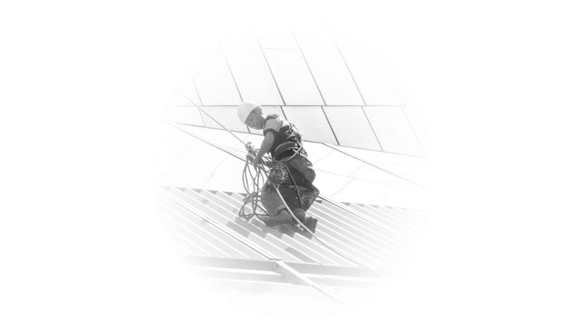 Professional construction worker in safety gear performing high-altitude building maintenance.