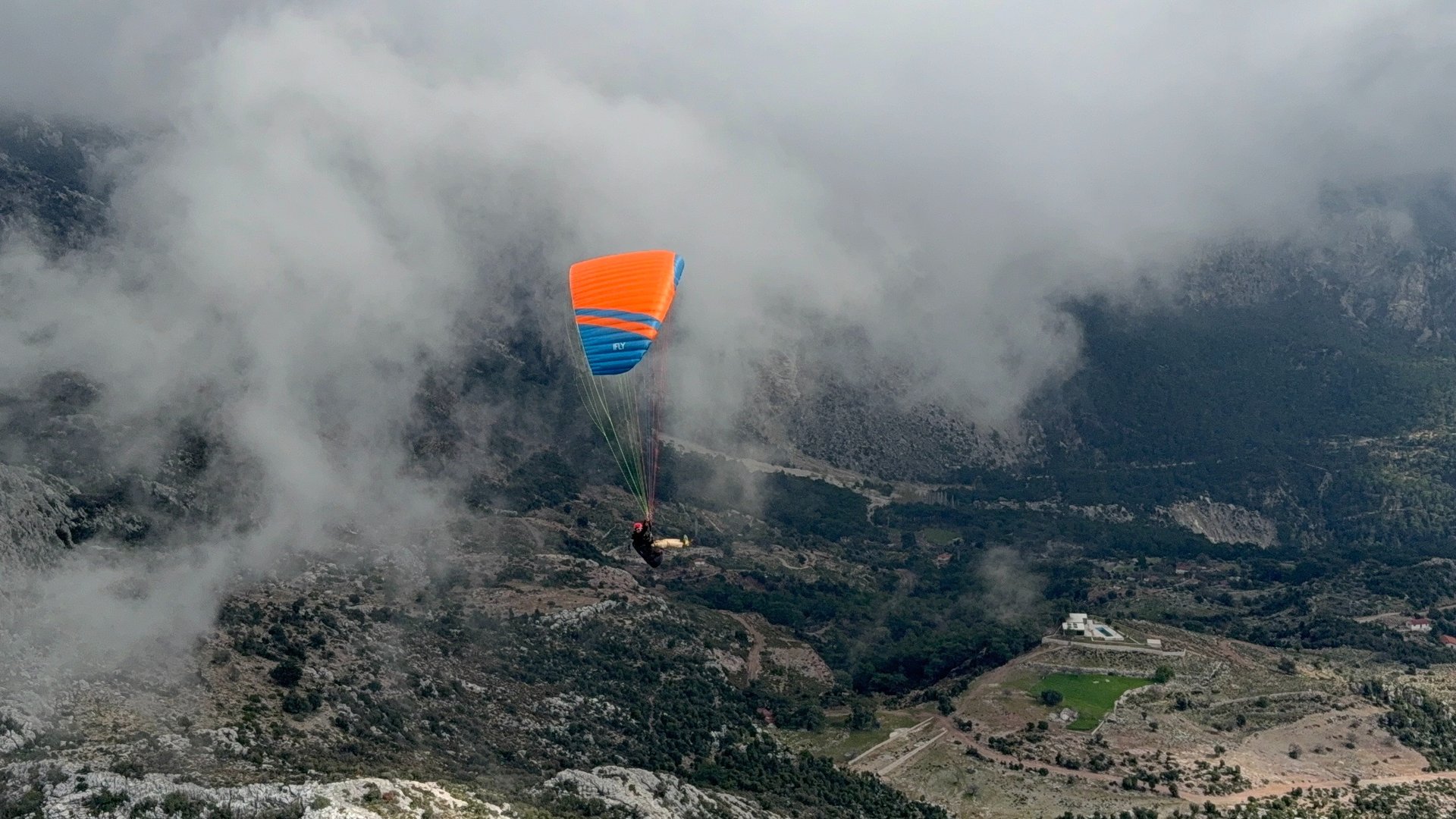 safe EN-A paraglider flying over clouds