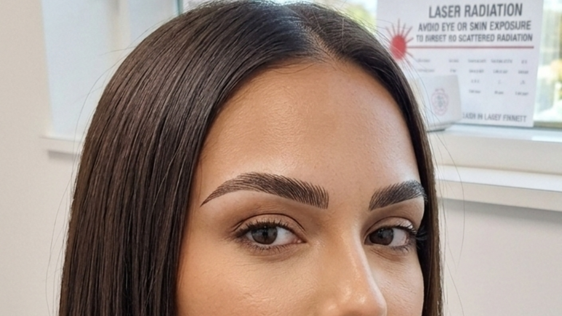 Professional microbladed eyebrows on a woman featuring precise hair strokes and a defined arch shape.
