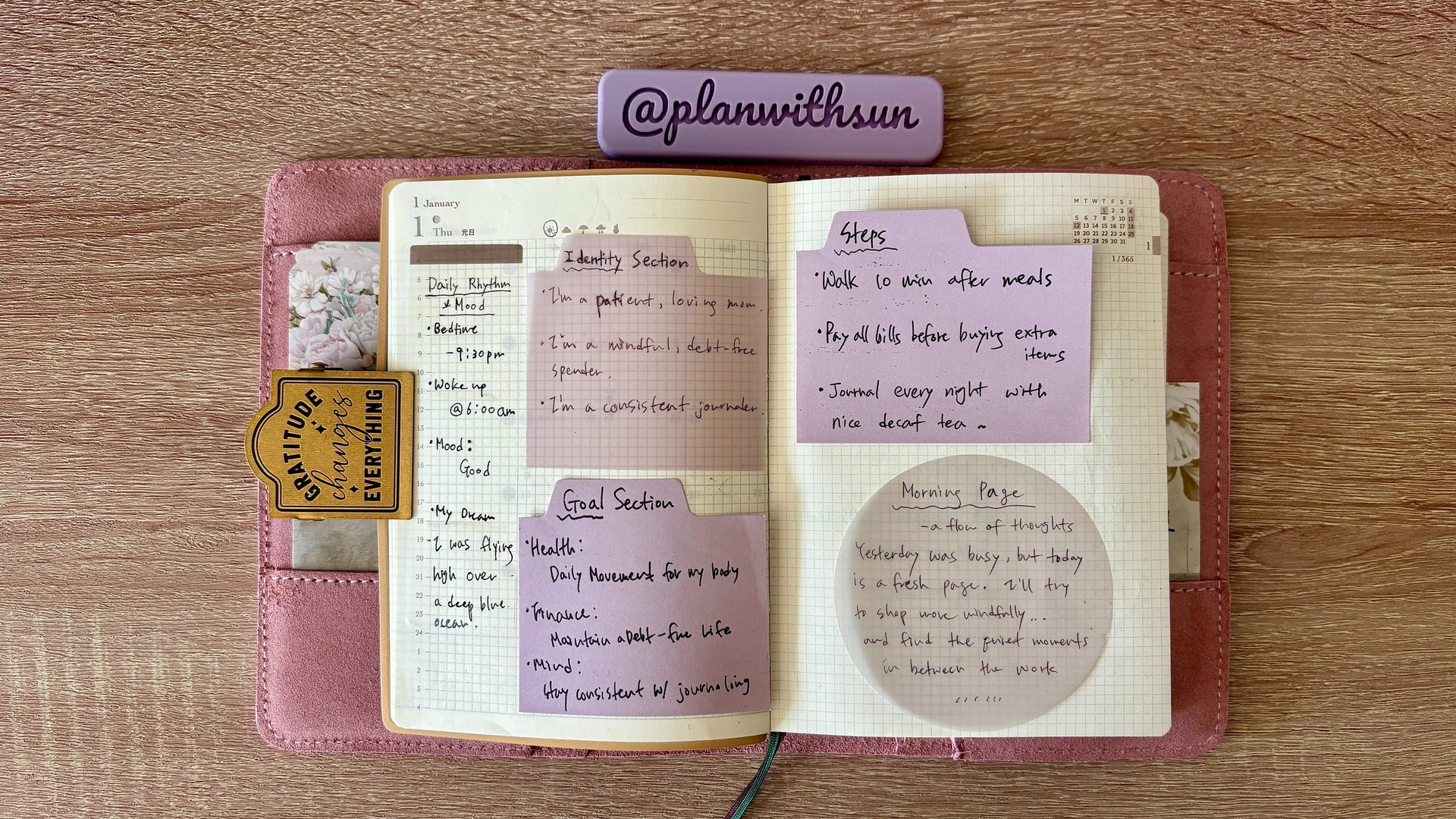 Open daily planner with handwritten notes, habit trackers, and purple sticky notes for goal setting.
