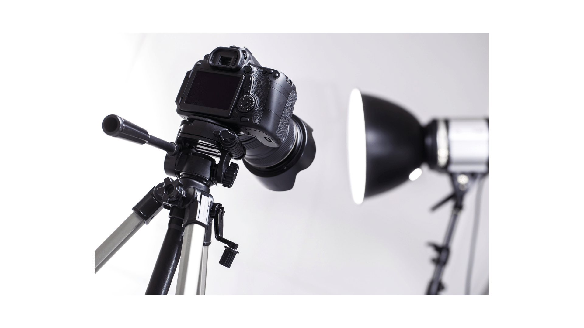 a camera and a light on a tripod