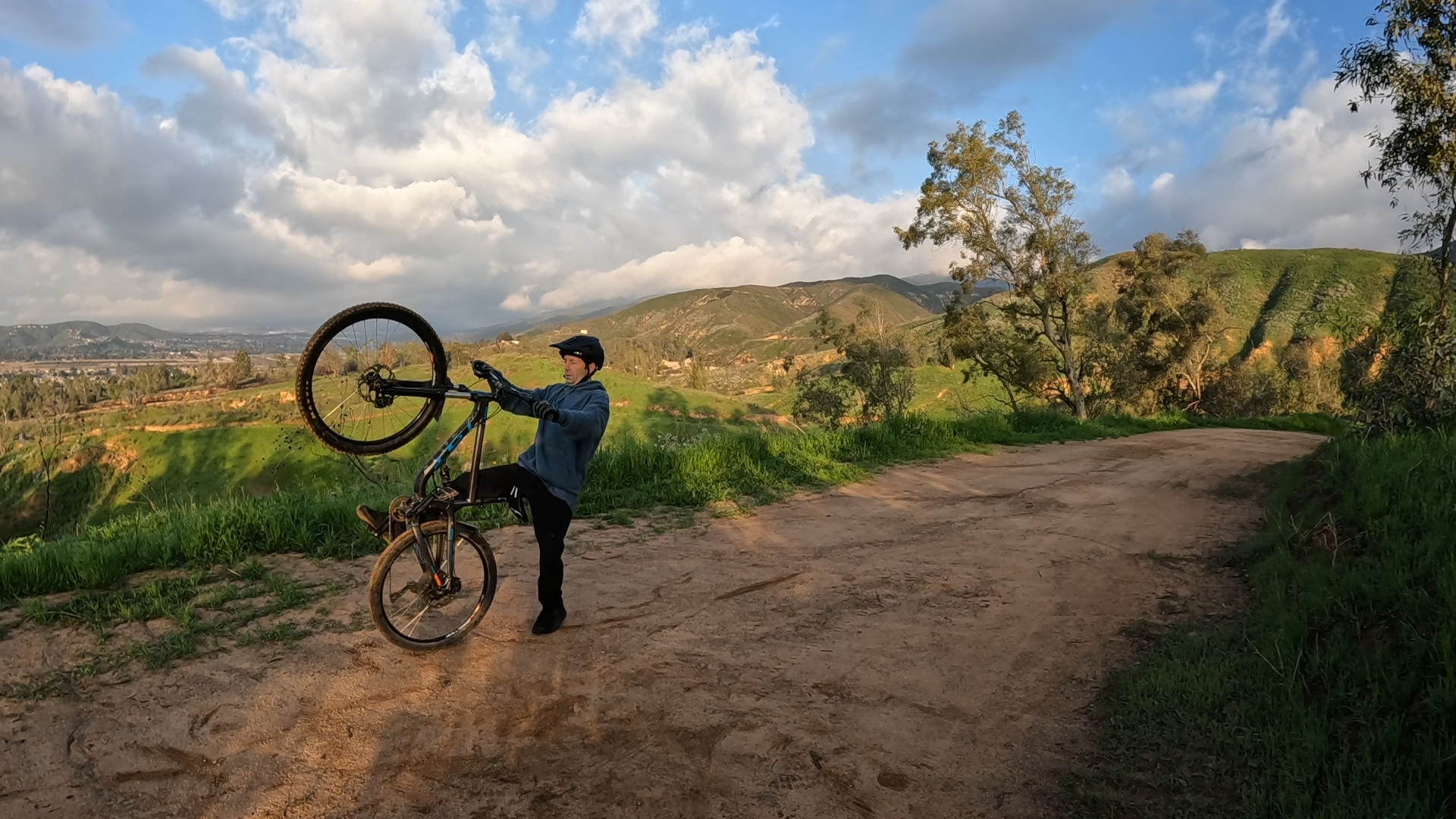 mountain biker stepping off back of bike after loopout on wheelie