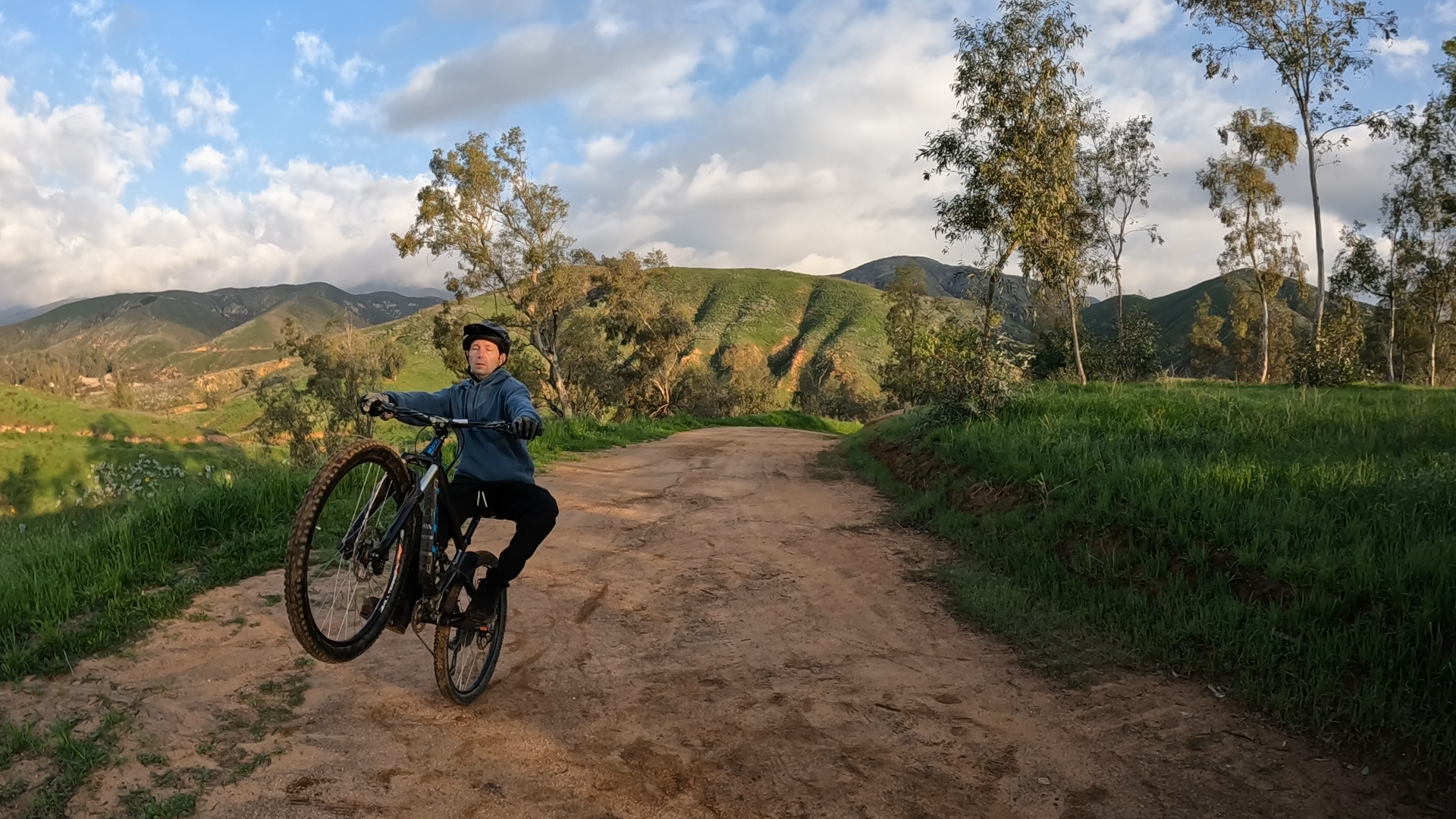 mountain biker practicing using rear brake to keep from looping out on wheelie