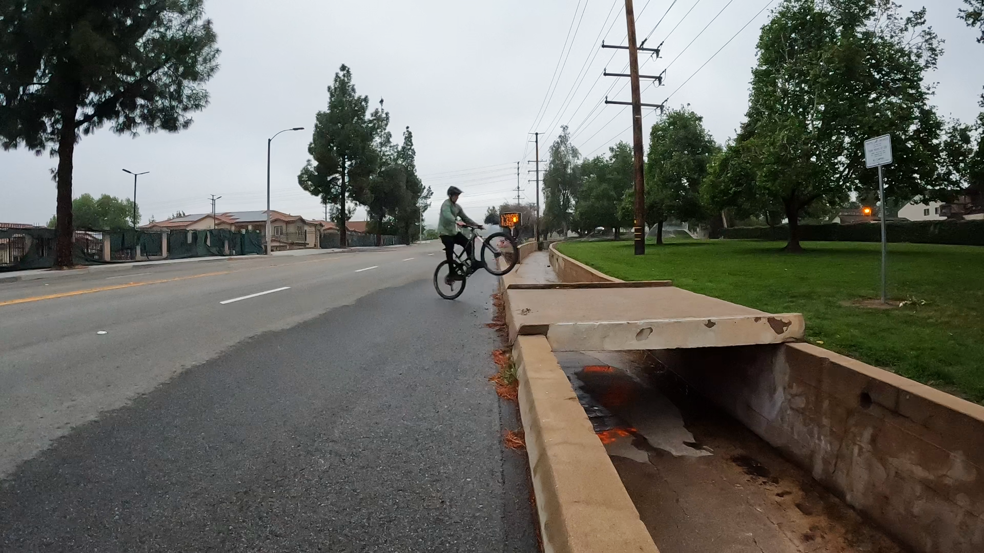 mountain biker bunnyhopping up a curb