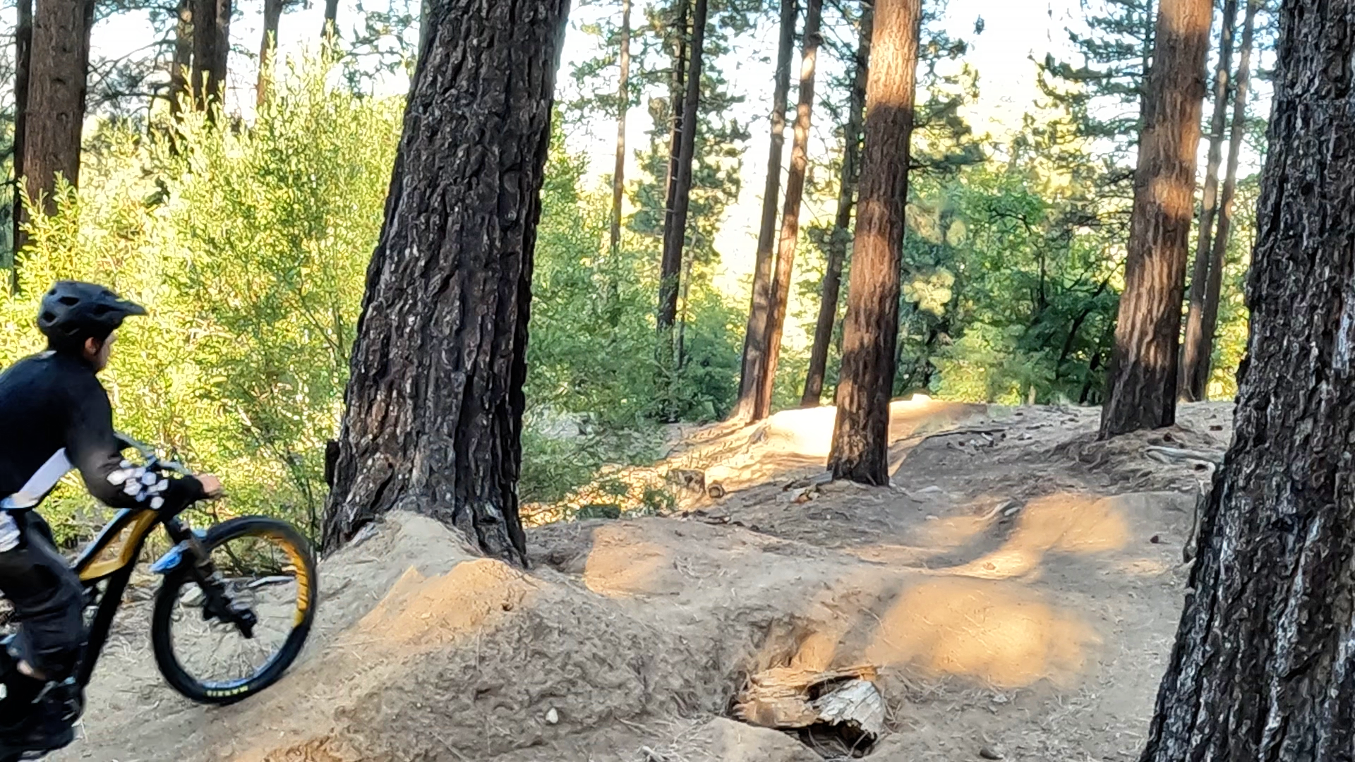 Mountain biker preloading up to a jump mtb tutorial 