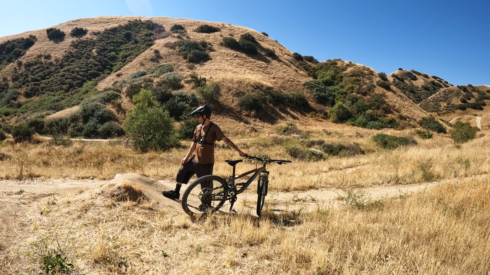 mountain biker looking at a jump trying judge how much speed they need to clear the gap