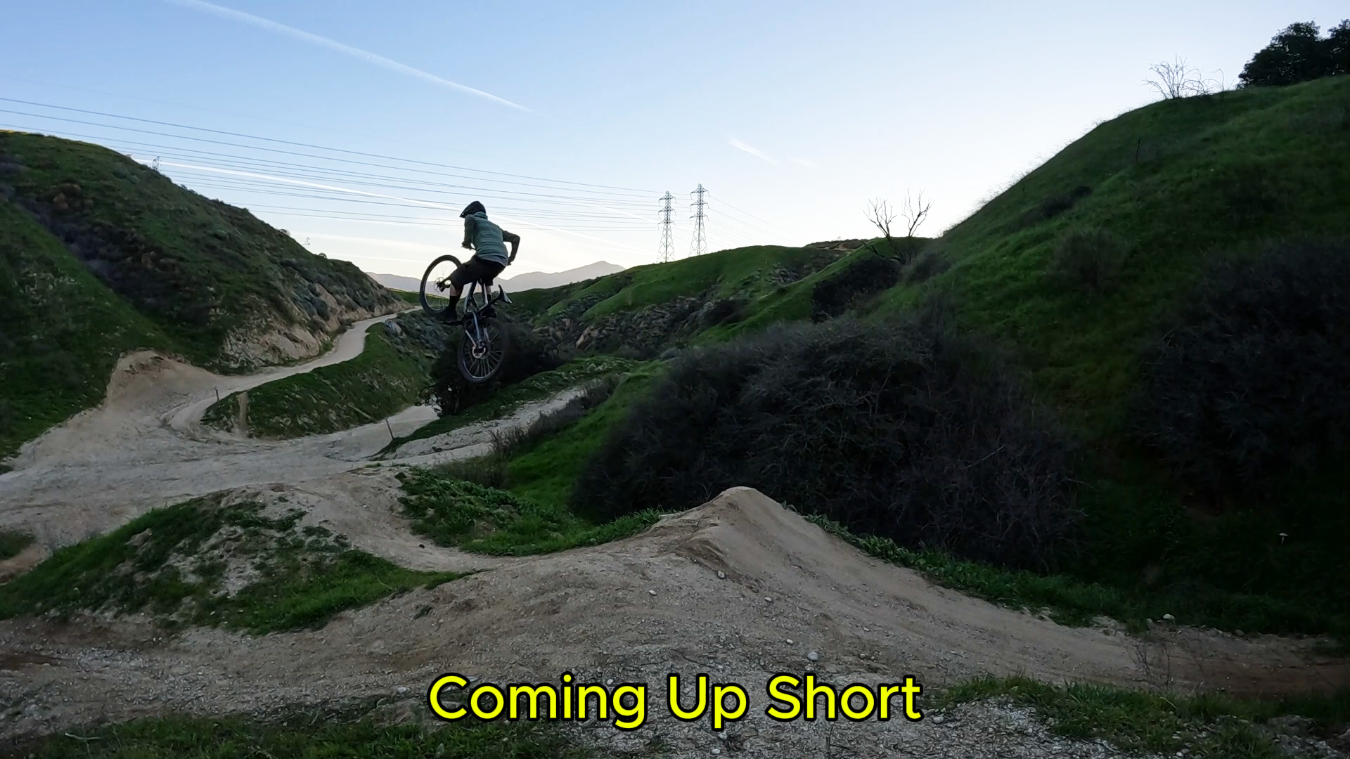 mountain biker with front wheel up high on a jump