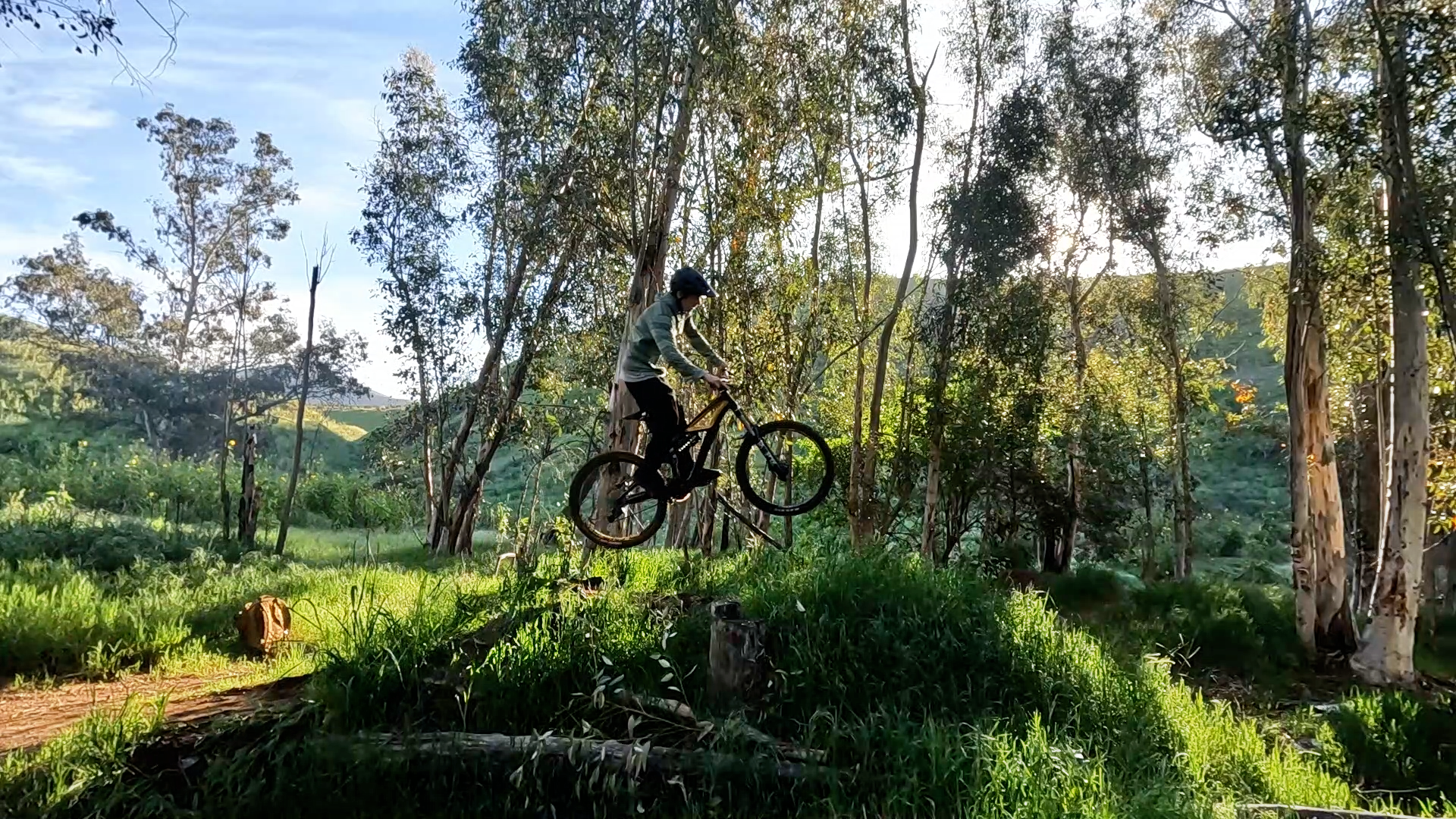 mountain biker in the air off a small jump