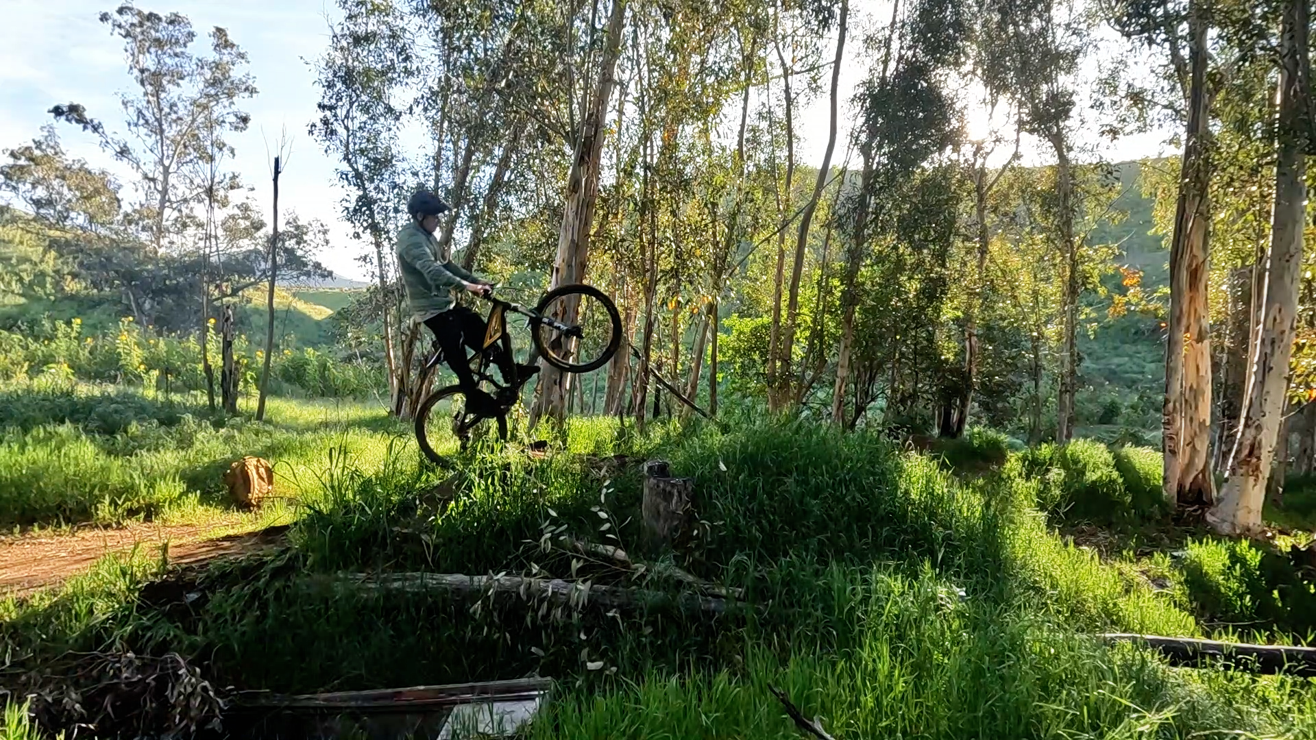 mountain biker lifting front wheel off a jump