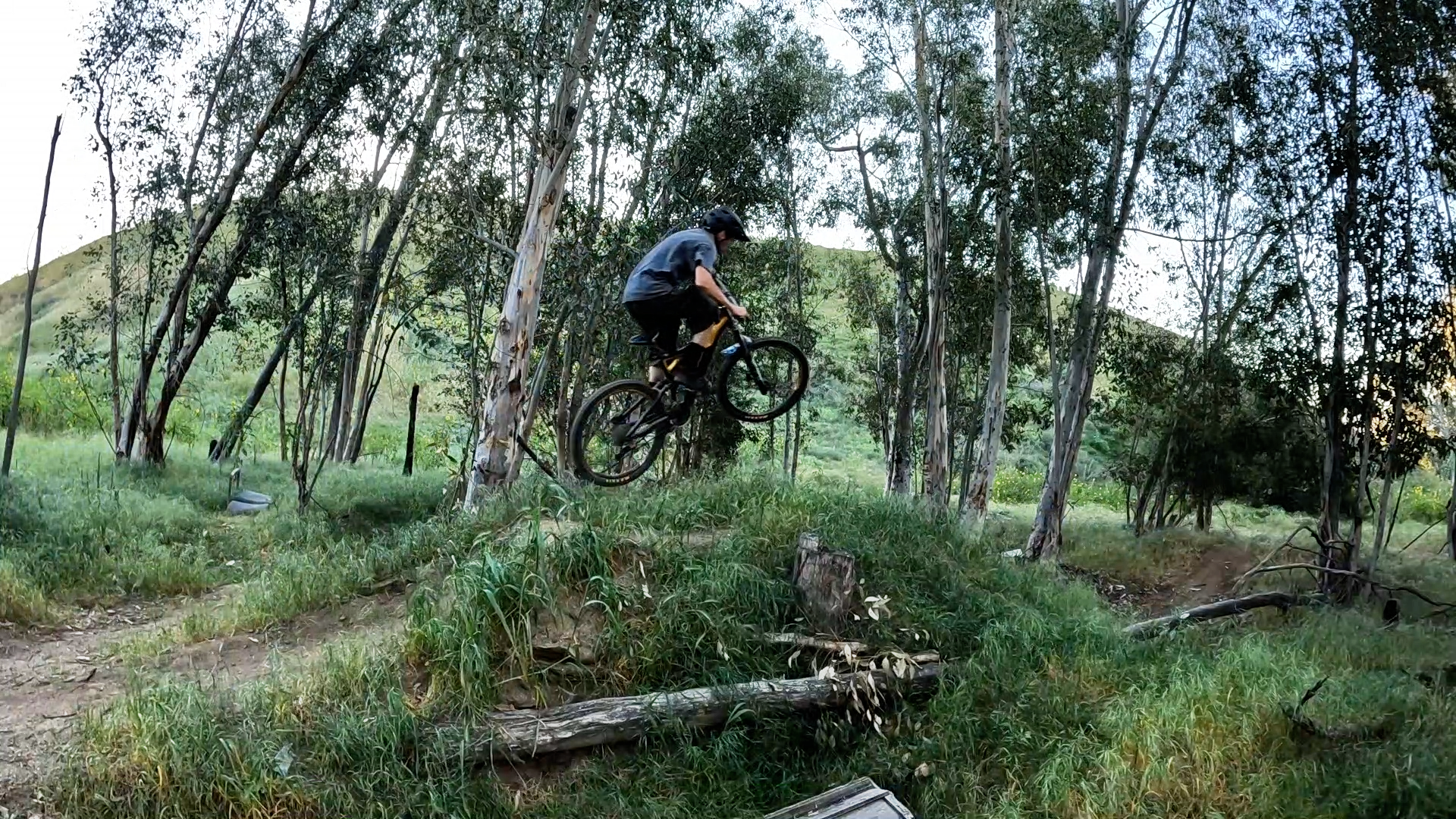 mountain biker staying low off a jump for speed