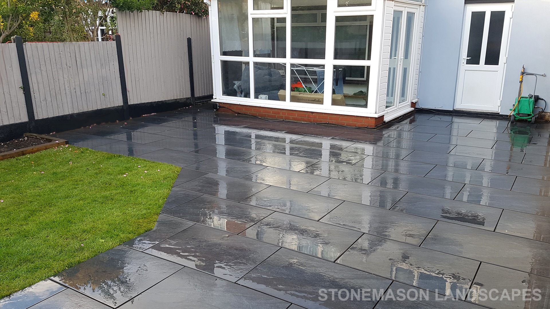 Grey sandstone circle paving slabs with charcoal edging