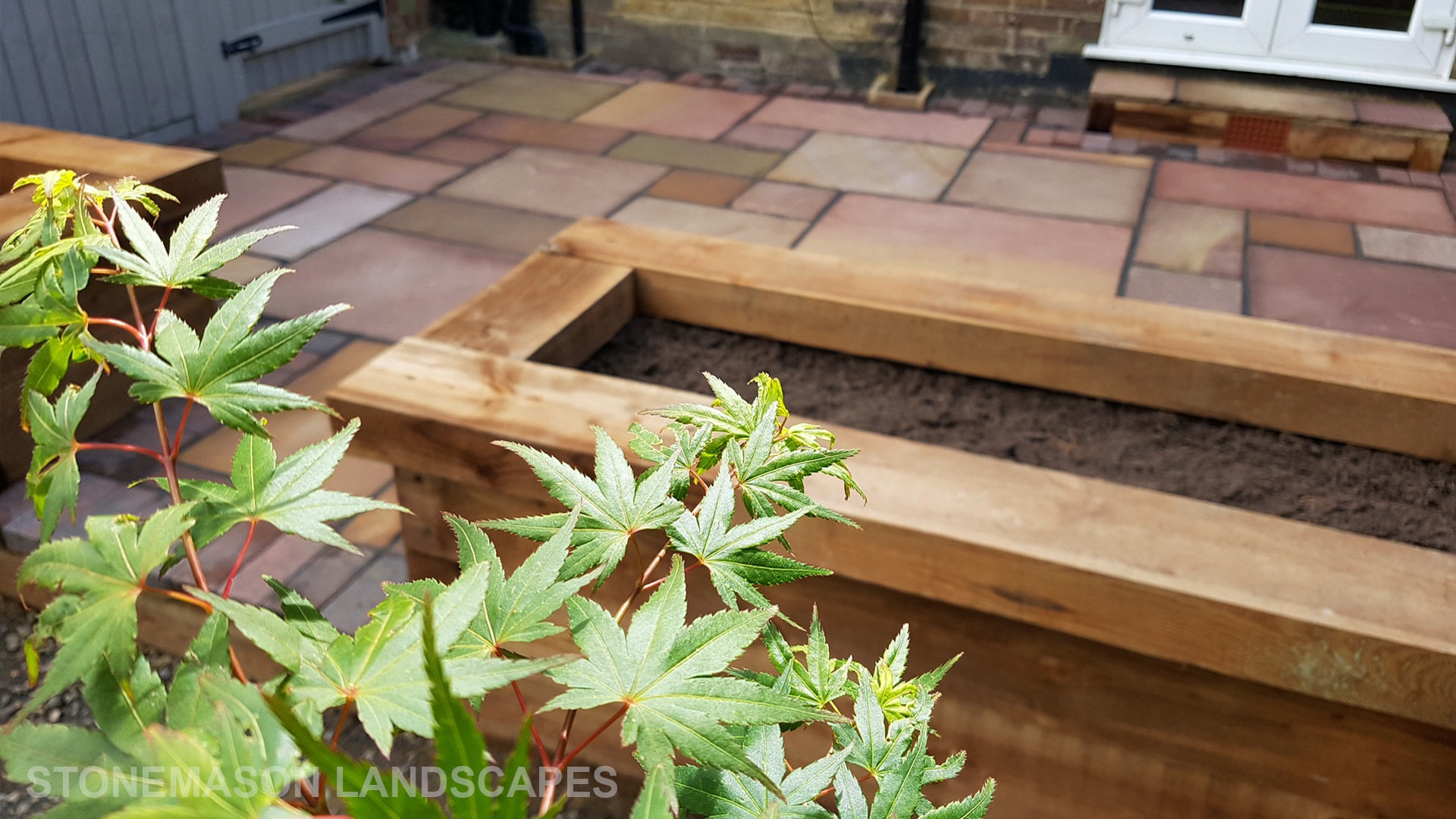 Colourful Sandstone Paving & Wooden Planters