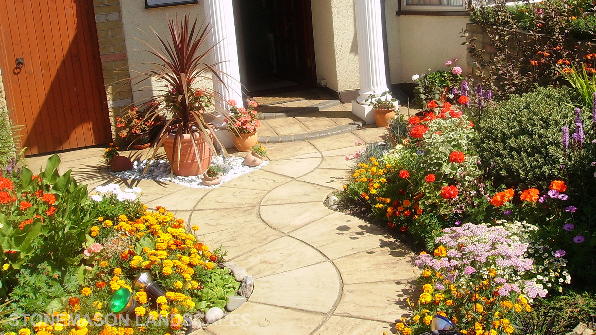 Curvey winding path, circle kits paving slabs weaving through lots of beautiful plants & flowers