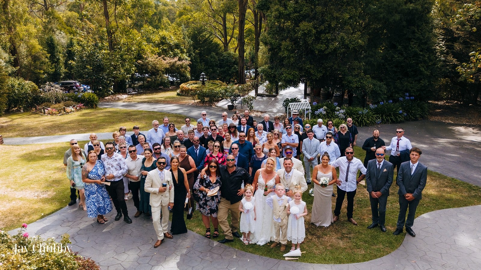 Large family group photo at Avalon Castle Melbourne wedding outdoor garden