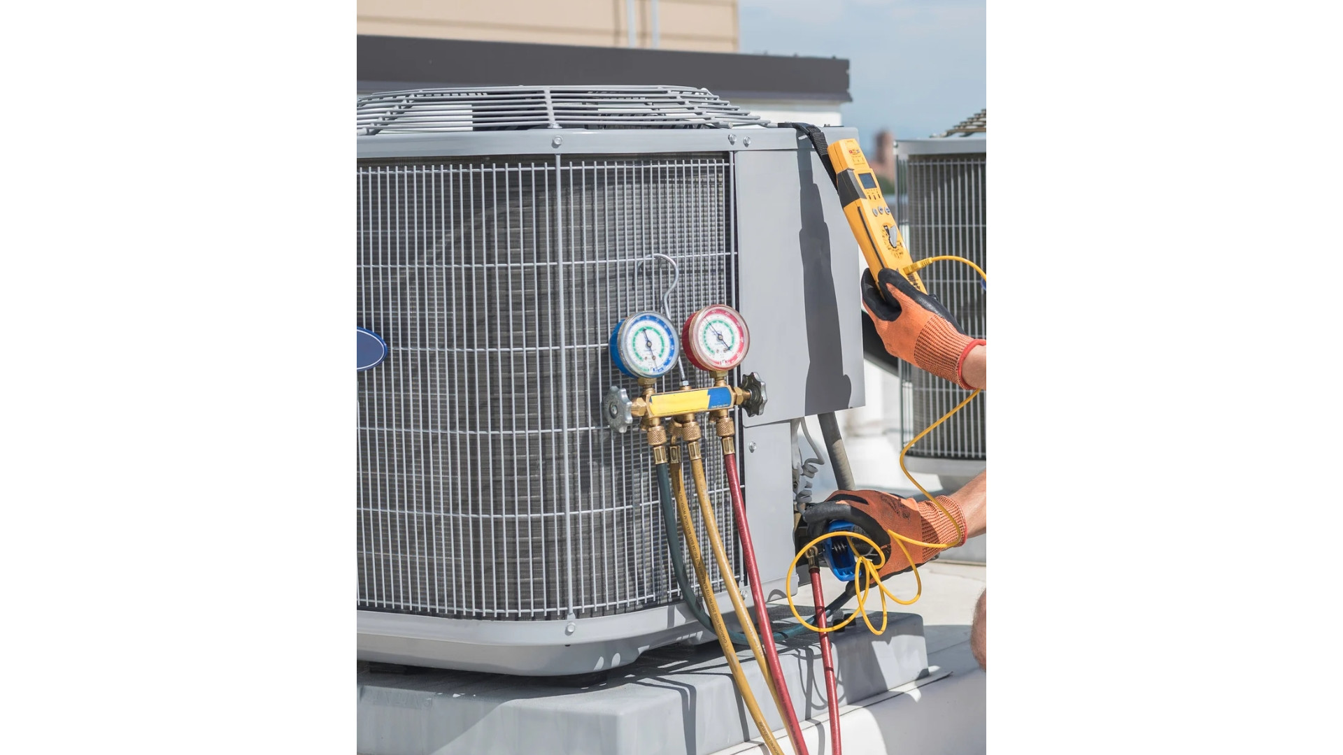 An HVAC technician uses pressure gauges and a multimeter to perform maintenance on an AC unit.