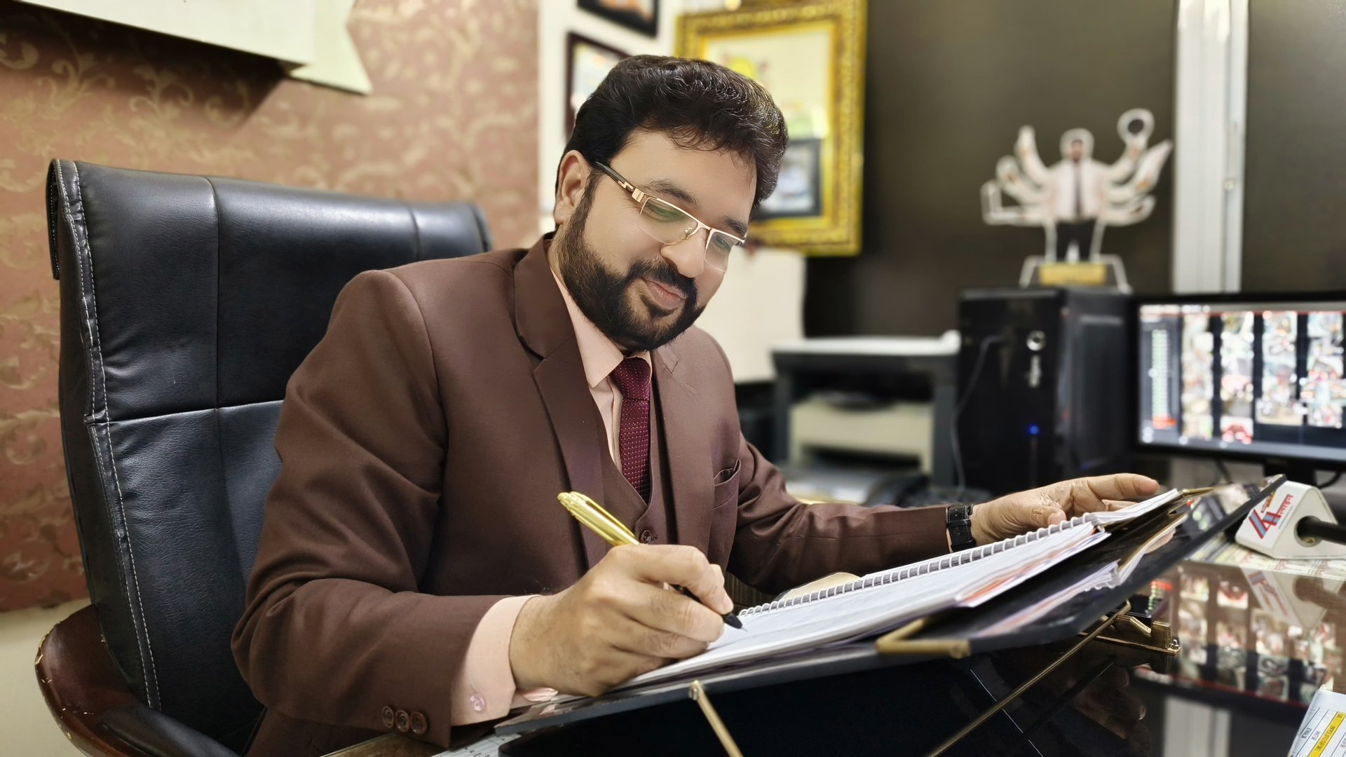 Mentor reviewing notes and documents in a professional workspace.