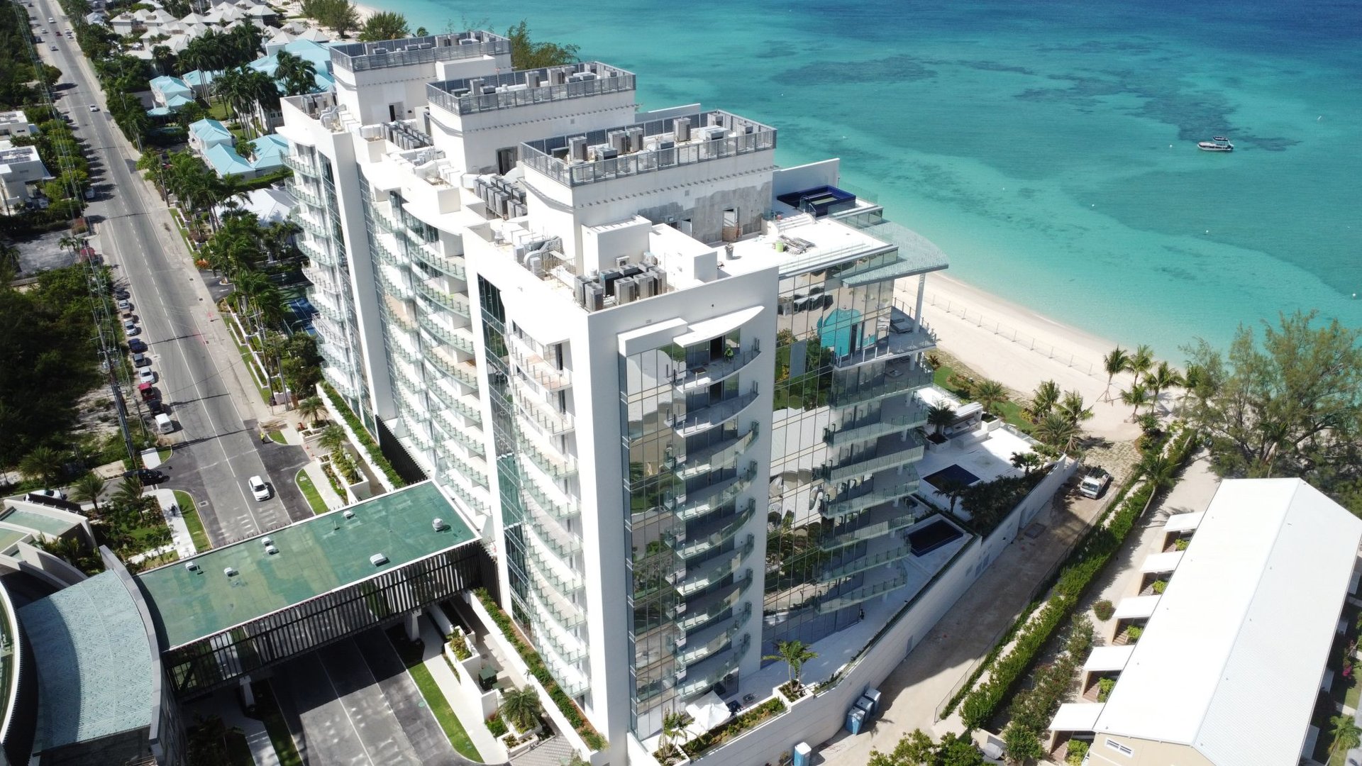 Luxury residential high-rise—The Watermark, Cayman, viewed from the beach with modern architect