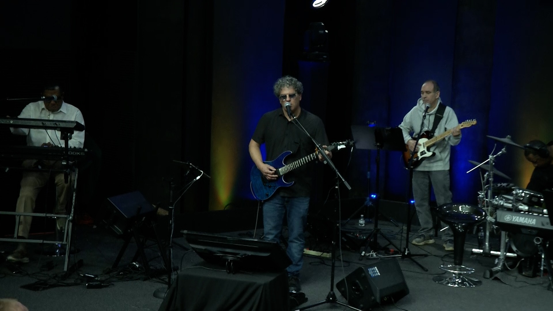 a man playing guitar in a band