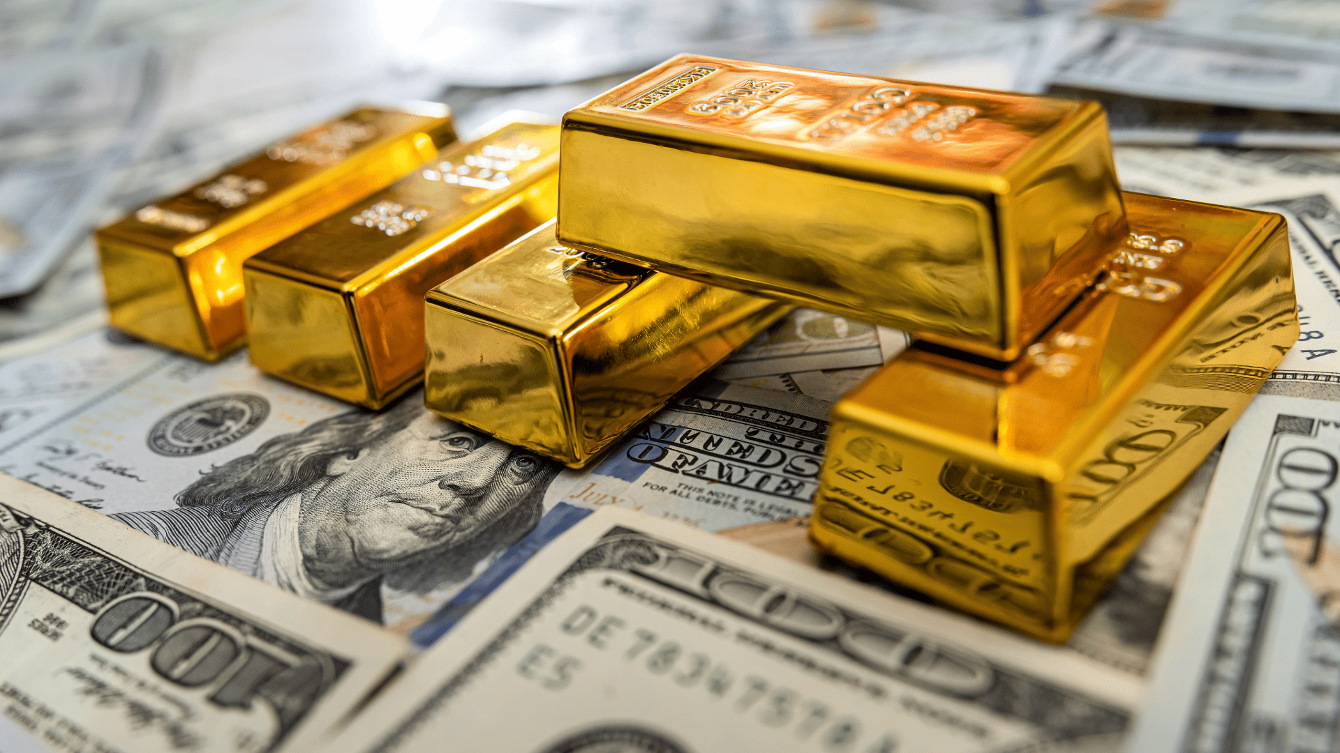 high quality gold bullion bars on top of US money