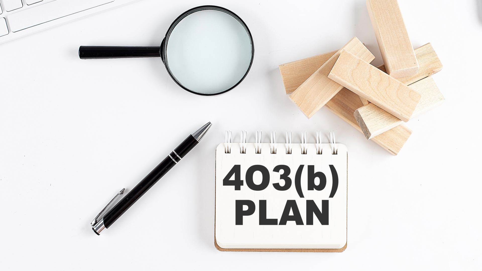 magnifying glass a pen and blocks for 403b plans