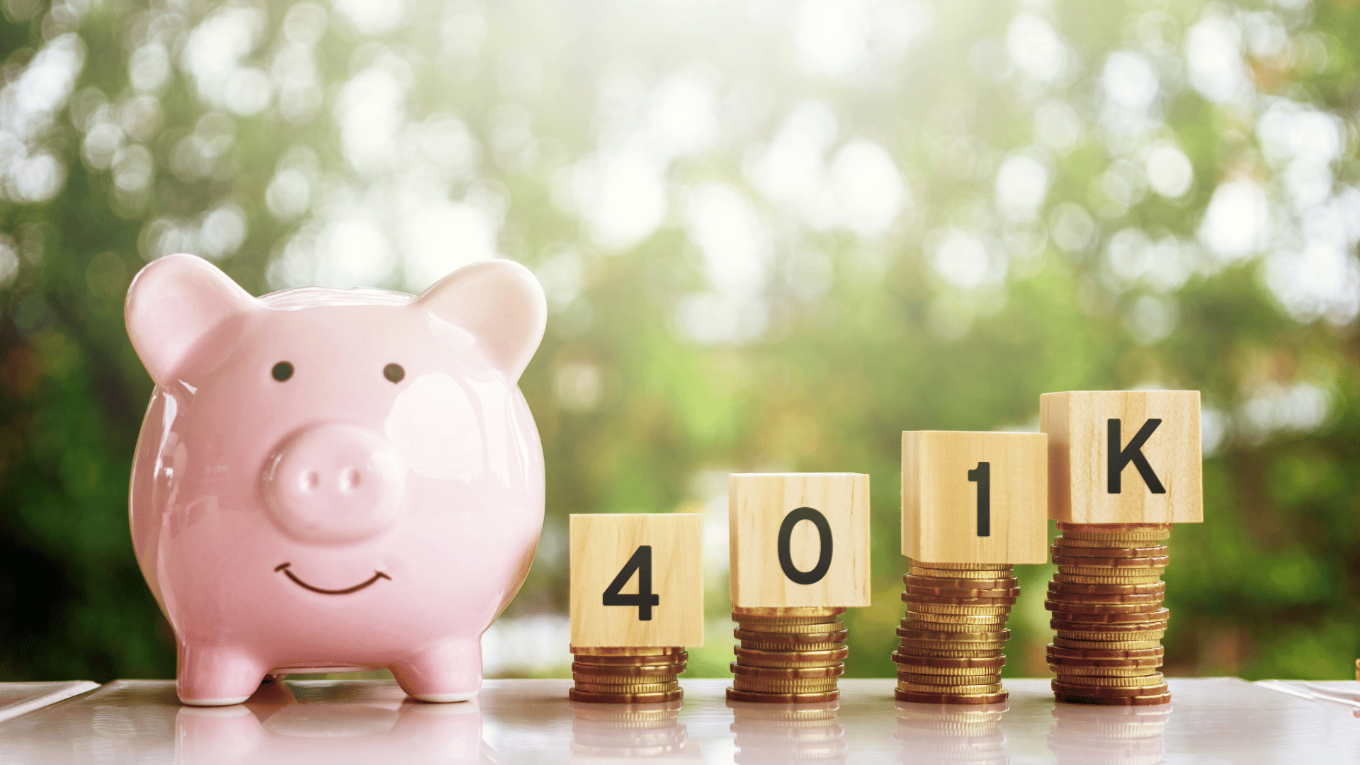 piggy bank and 401k blocks on gold coins