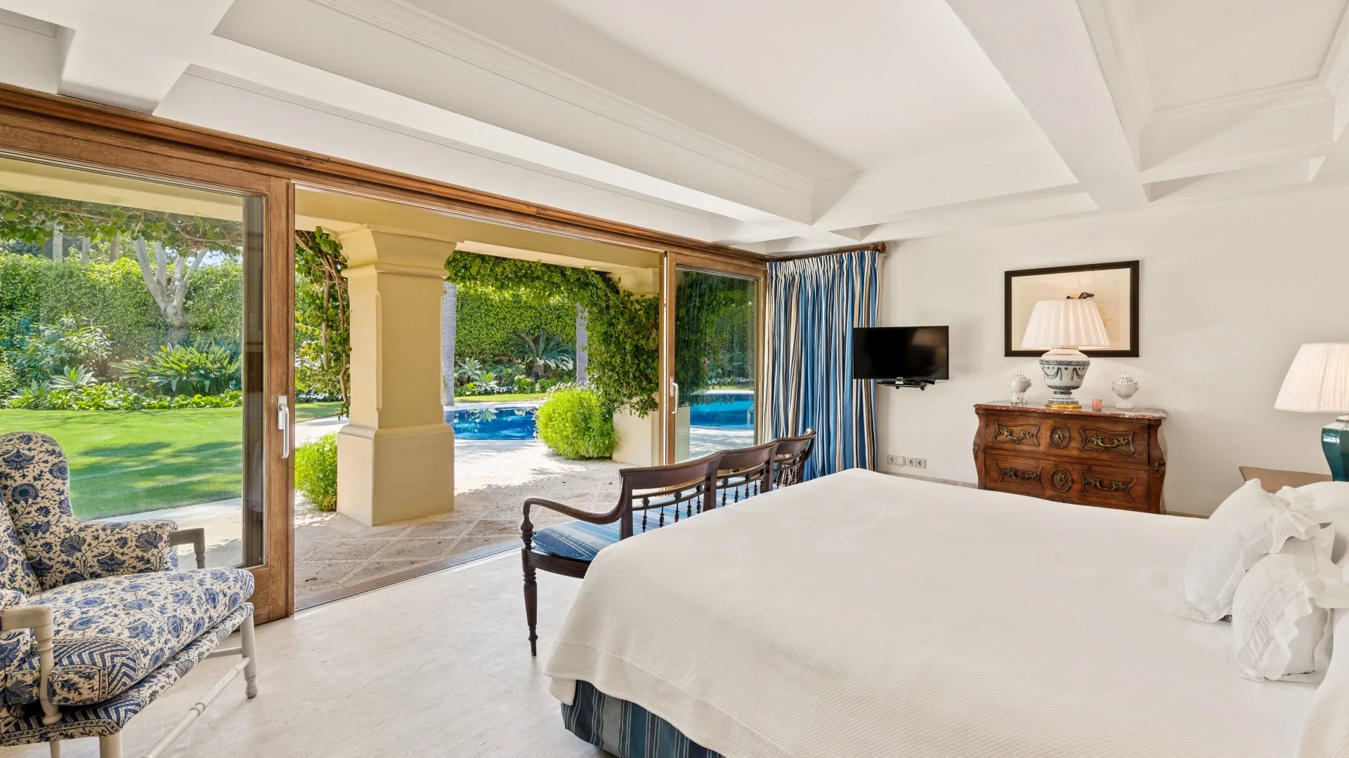 Garden-view bedroom with terrace access in Marbella villa