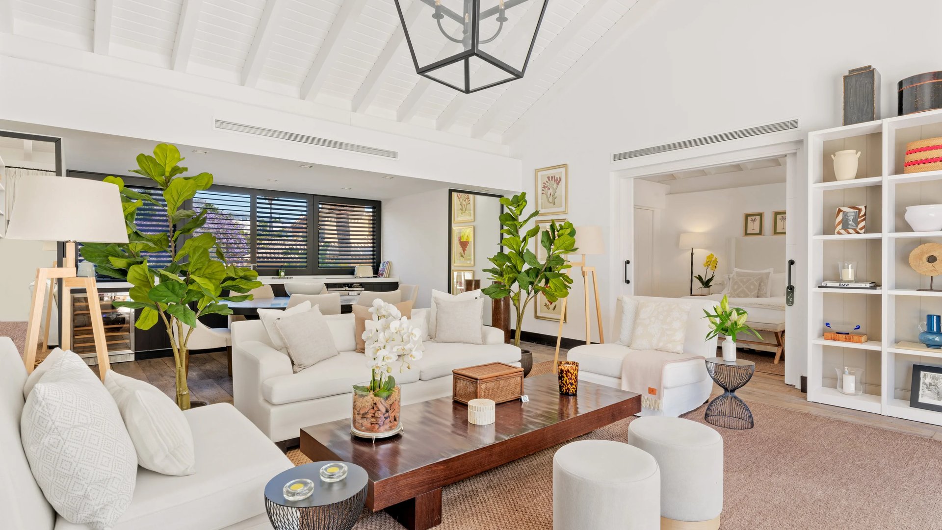 Bright open plan living room with white sofas