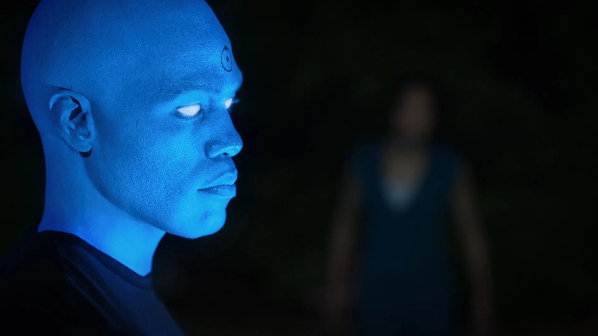 a man with blue eyes and a blue glow