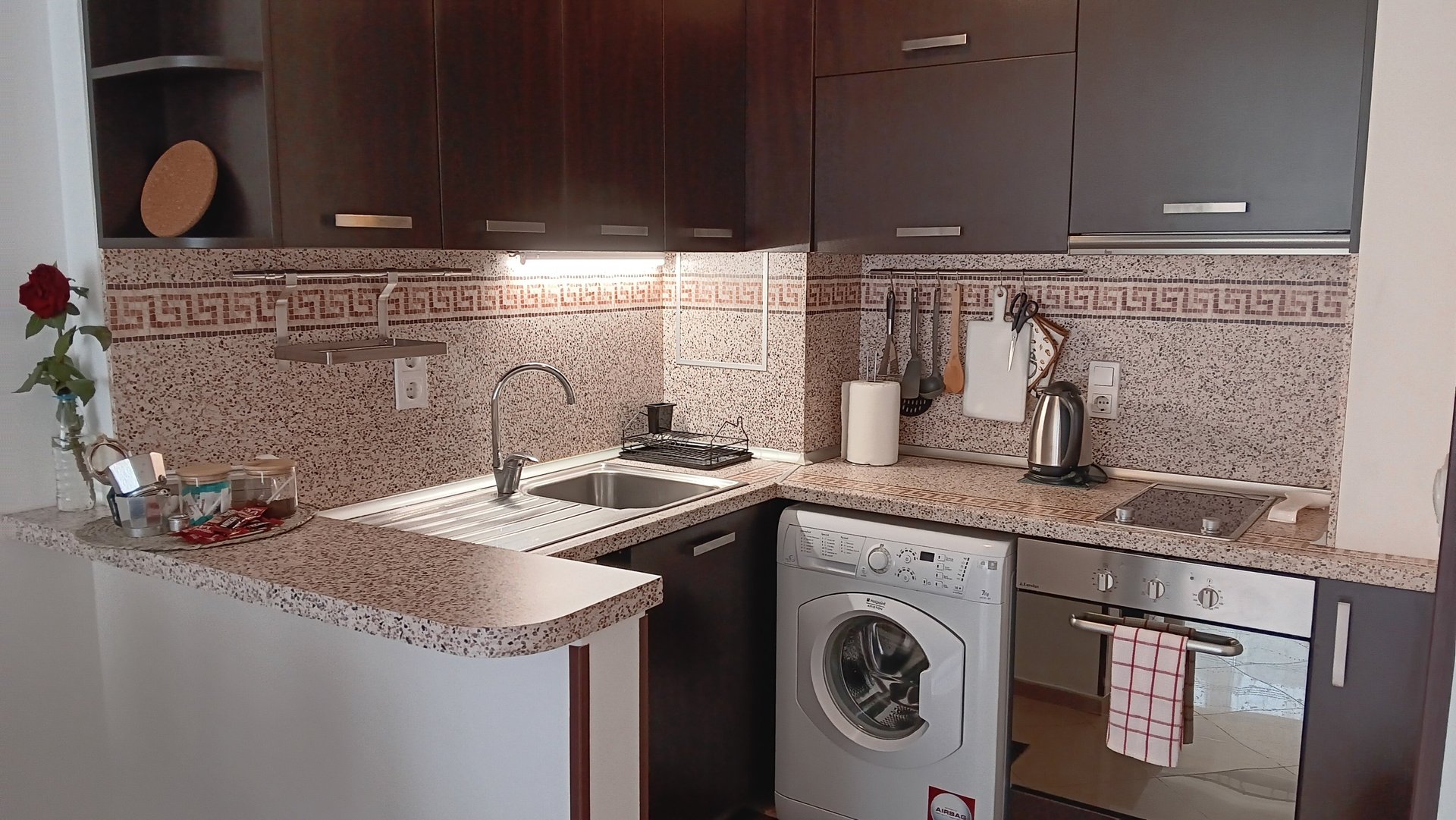 alt="Serenity Apartment fully equipped kitchen for guests"
