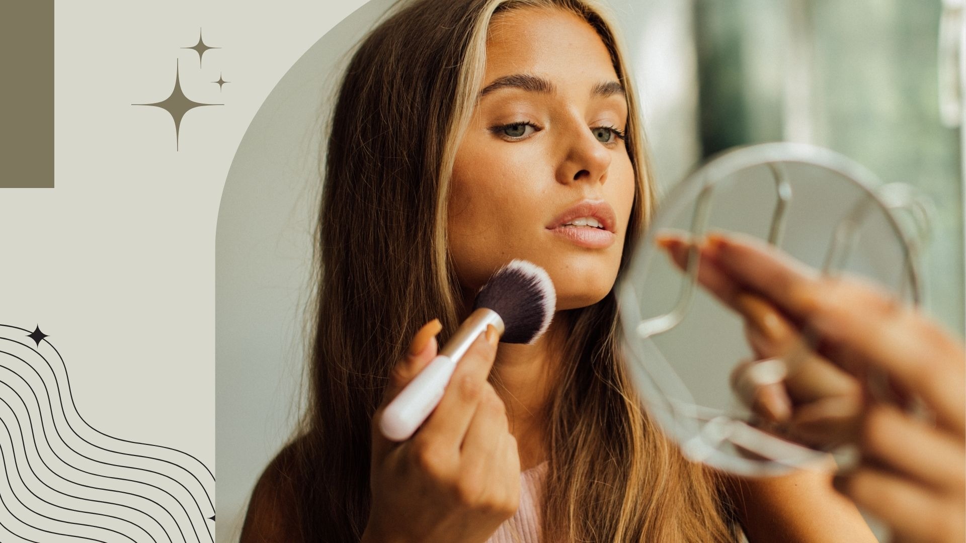A woman applying makeup with a fluffy brush while looking into a handheld mirror for a beauty routine.