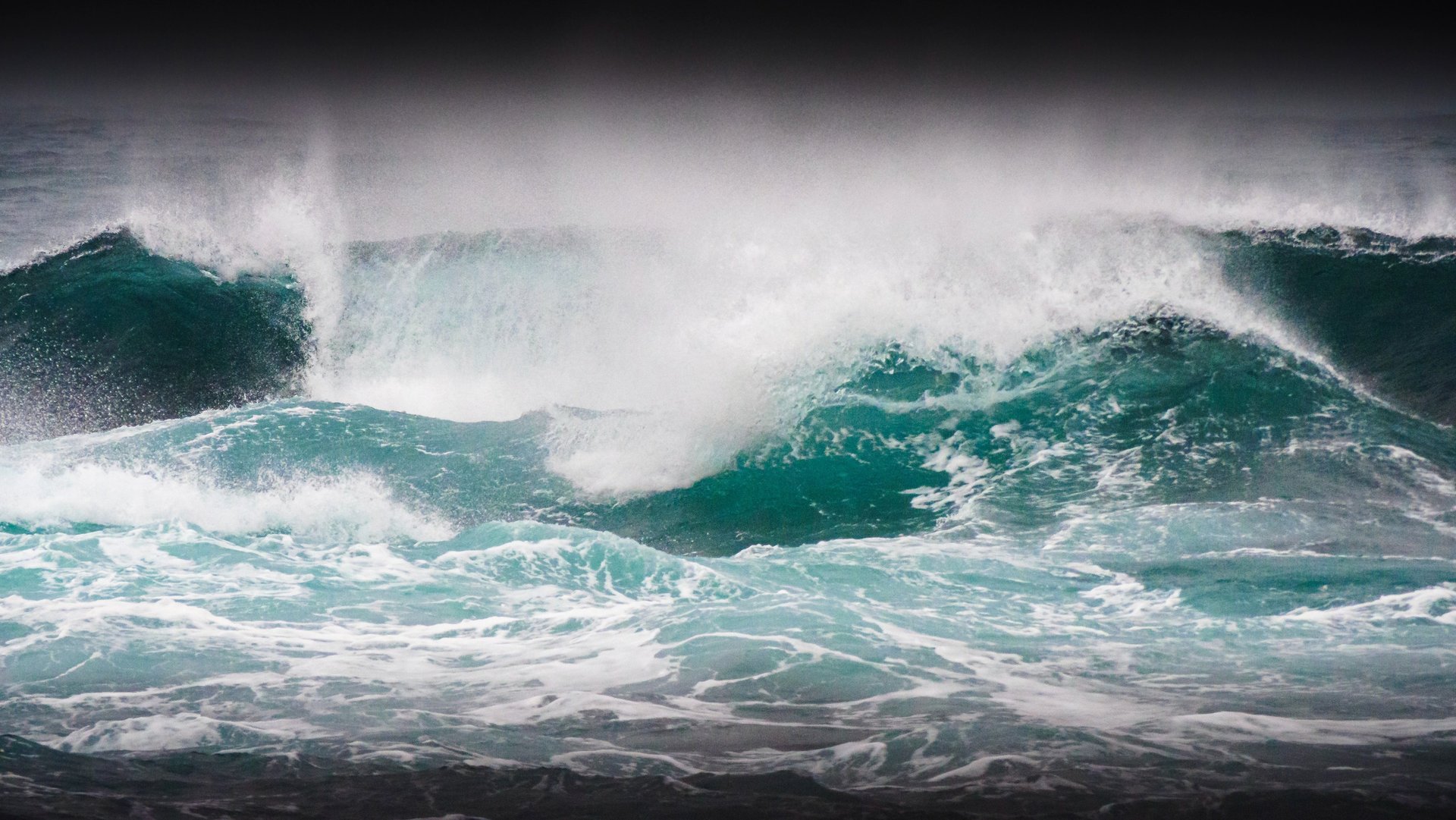 Powerful storm waves crashing against rugged cliffs, raw Atlantic energy and dramatic Faroe Islands coastline
