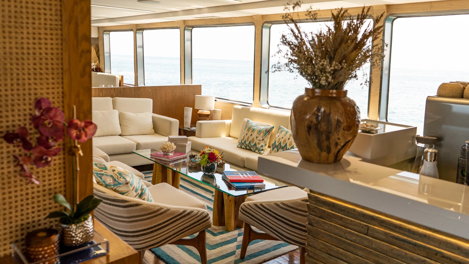 Refined yacht interior lounge with panoramic sea views, showcasing comfort and design