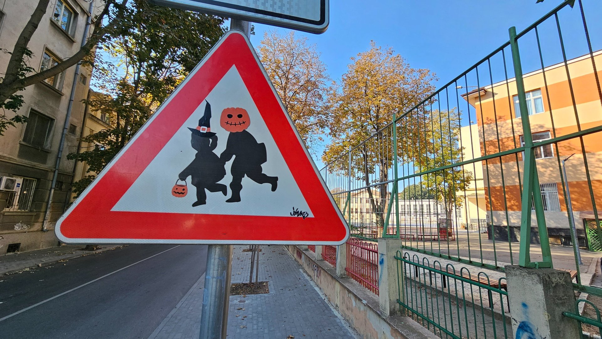 a street sign with a cartoon character on it