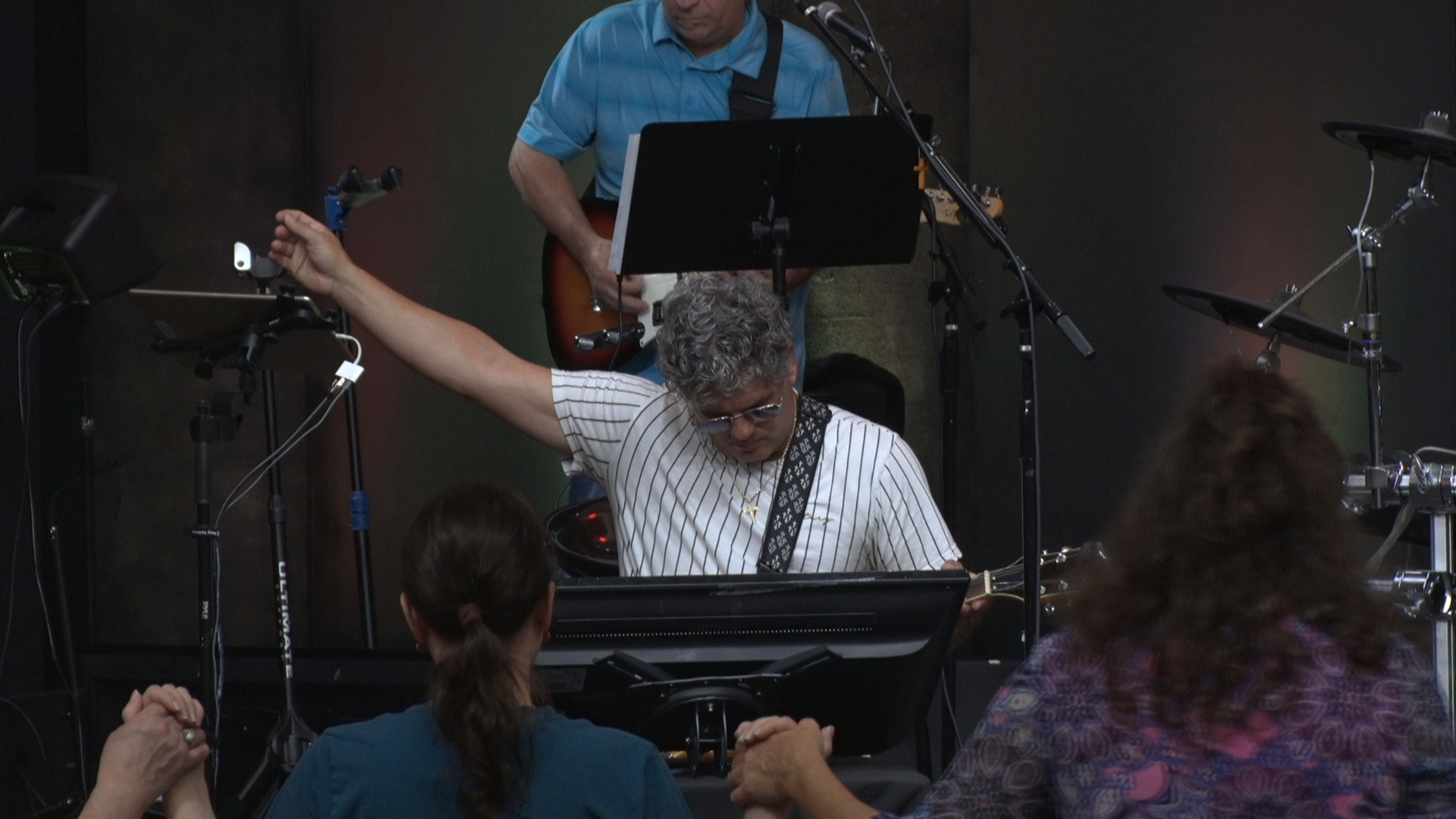 a man playing a keyboard and a woman singing