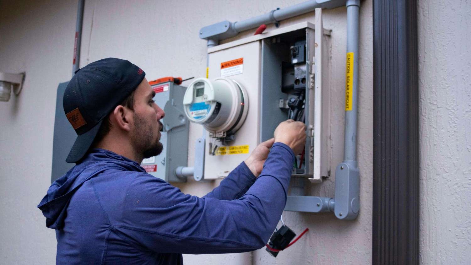 HVAC technician performing seasonal maintenance on an air conditioning unit at a Columbus Ohio home