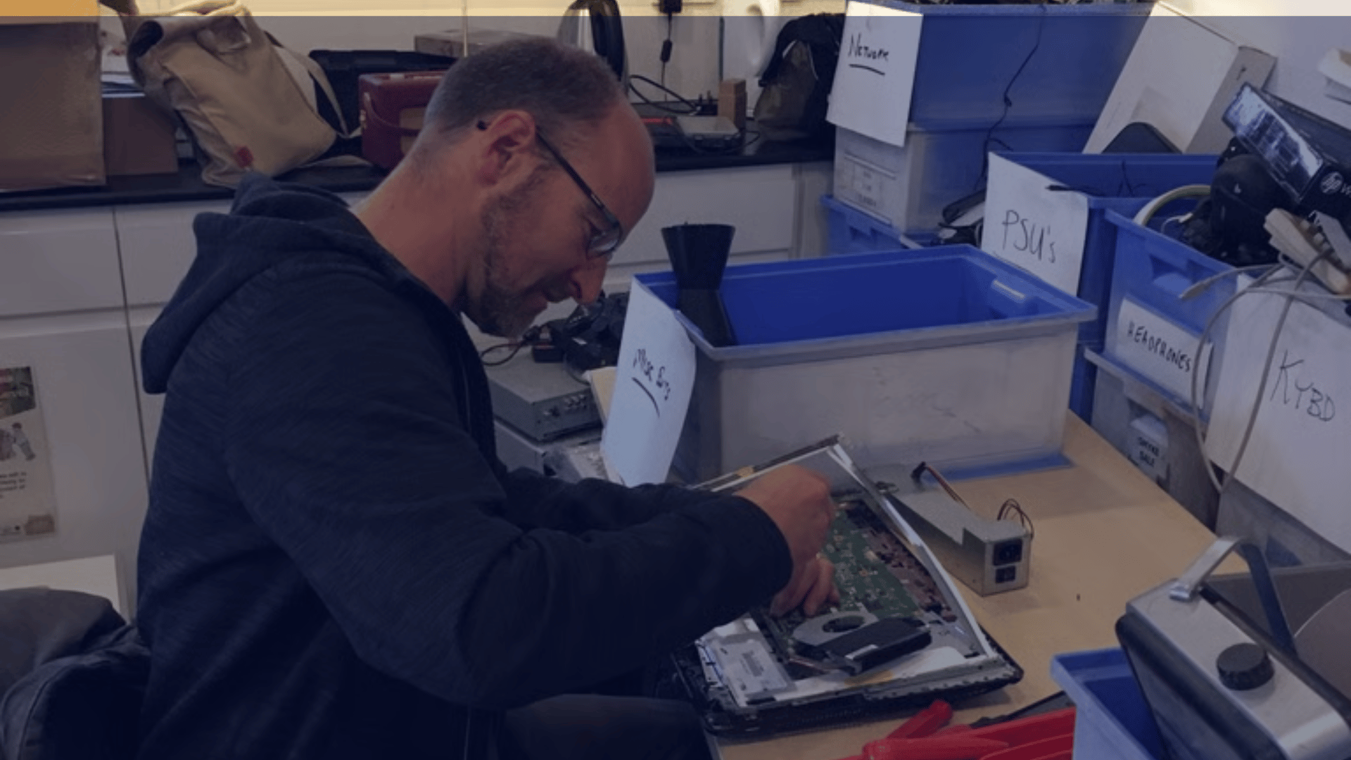 A TTB CircularIT employee disassembles a laptop to facilitiate responsible resource recovery