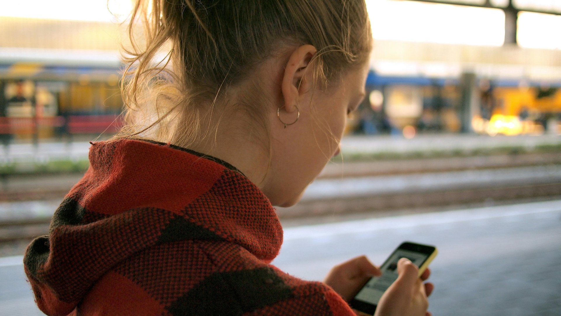 woman looking at phone with worried expression waiting for him to text back