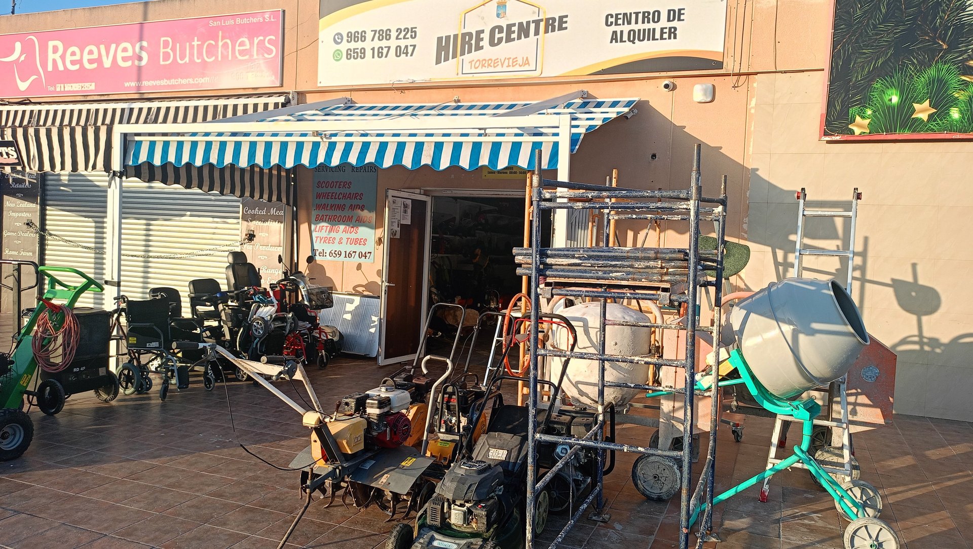 Torrevieja hire centre storefront with rental equipment like cement mixers, lawnmowers, and wheelchairs.